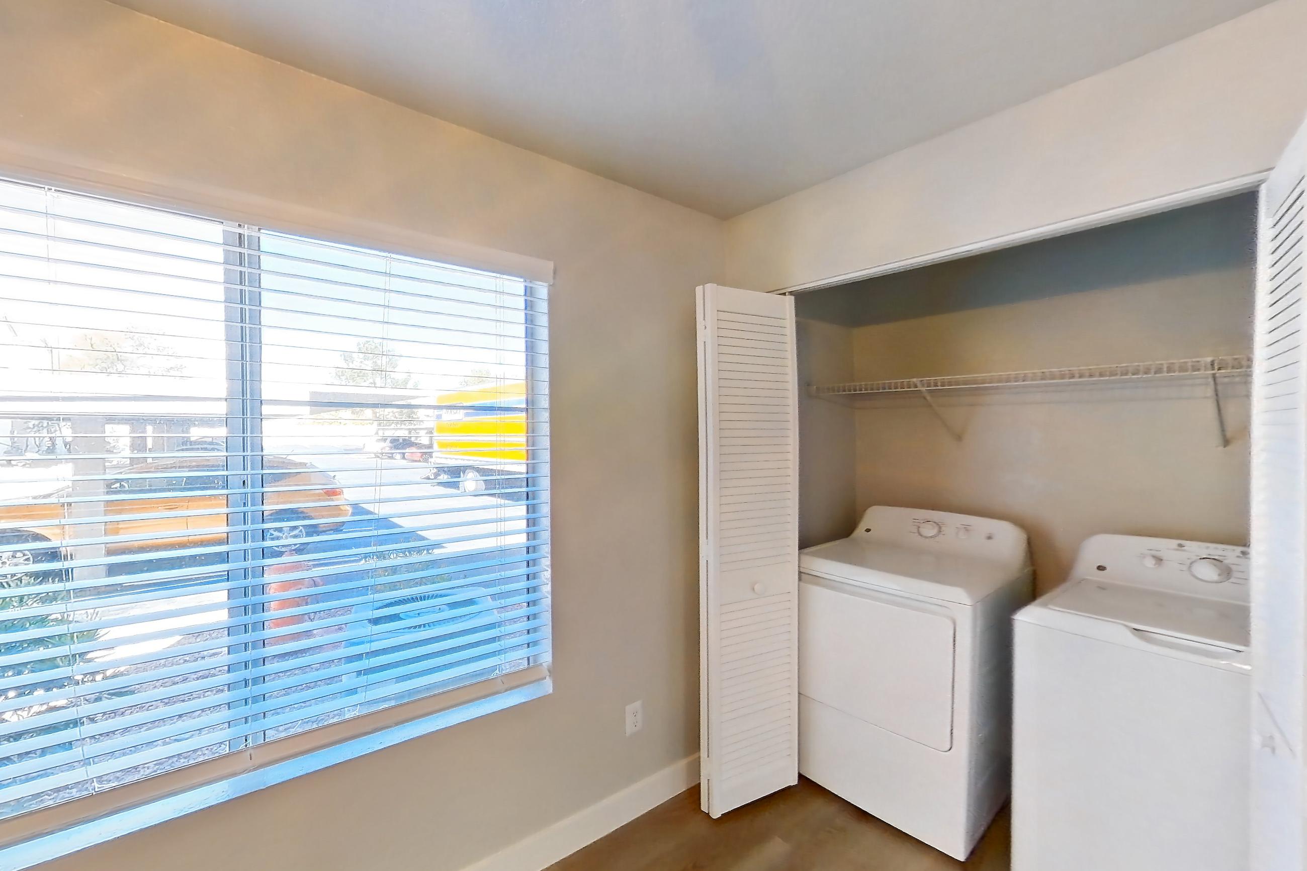 Dining room with in-unit laundry and light wood-finish flooring, Apartment 1109 at Vintage Pointe