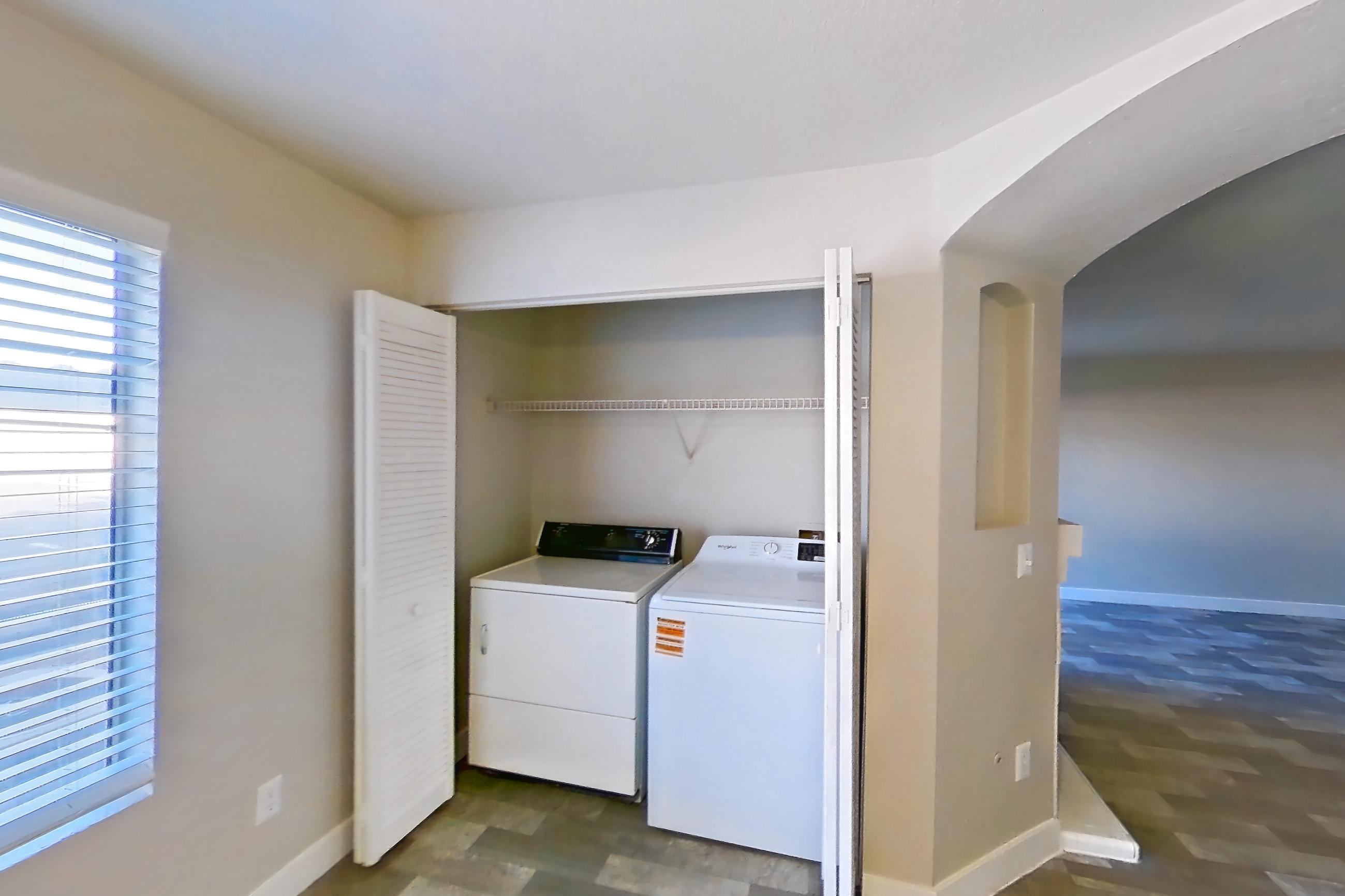 Dining room with in-unit laundry, light stone countertops, and light wood-finish flooring, Apartment 1125 at Vintage Pointe