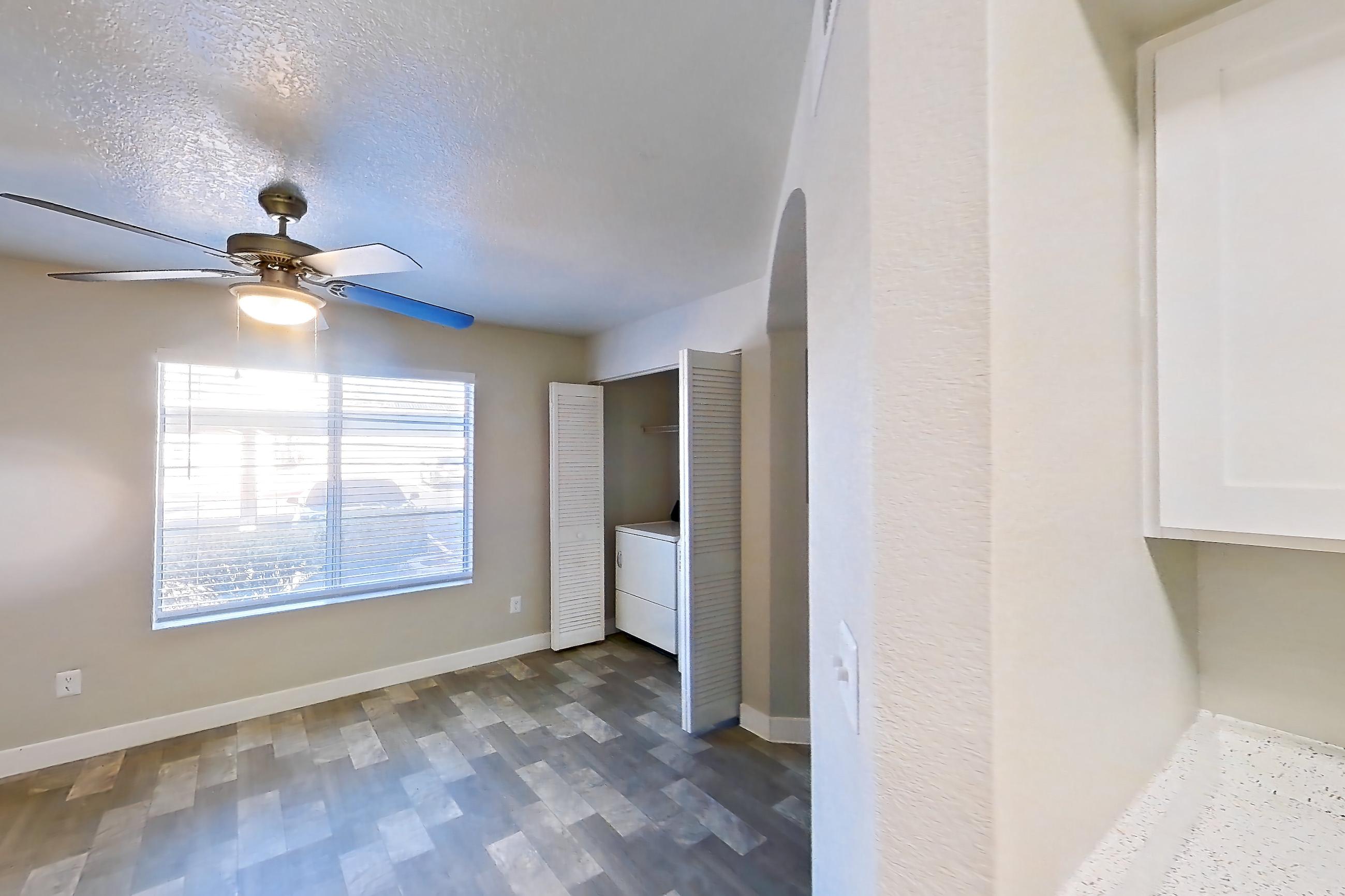 Kitchen with dishwasher, gas range, in-unit laundry, light stone countertops, light wood-finish flooring, microwave, oven/range, refrigerator, and stainless steel appliances, Apartment 1125 at Vintage Pointe