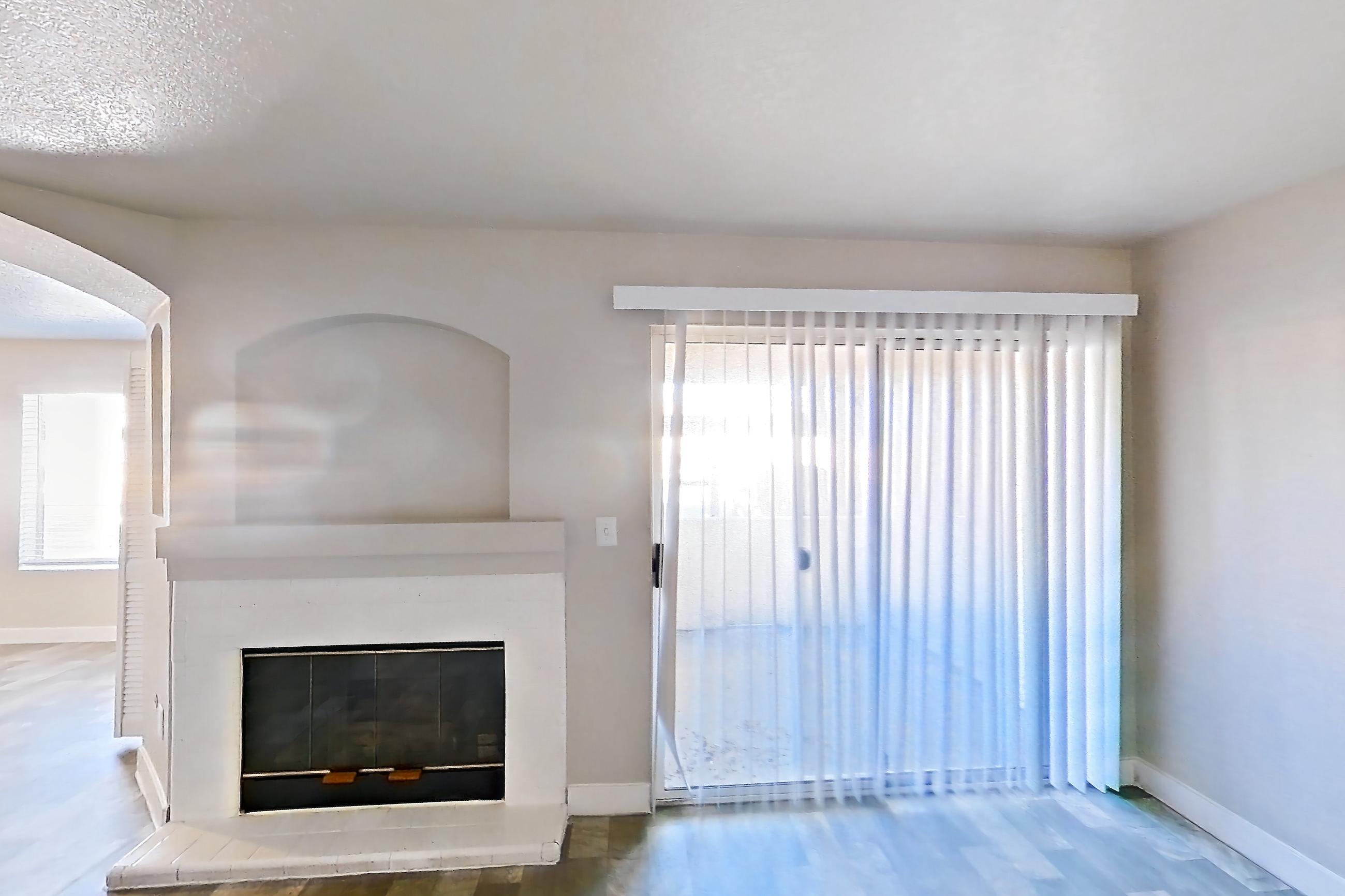 Living room with fireplace and light wood-finish flooring, Apartment 1125 at Vintage Pointe