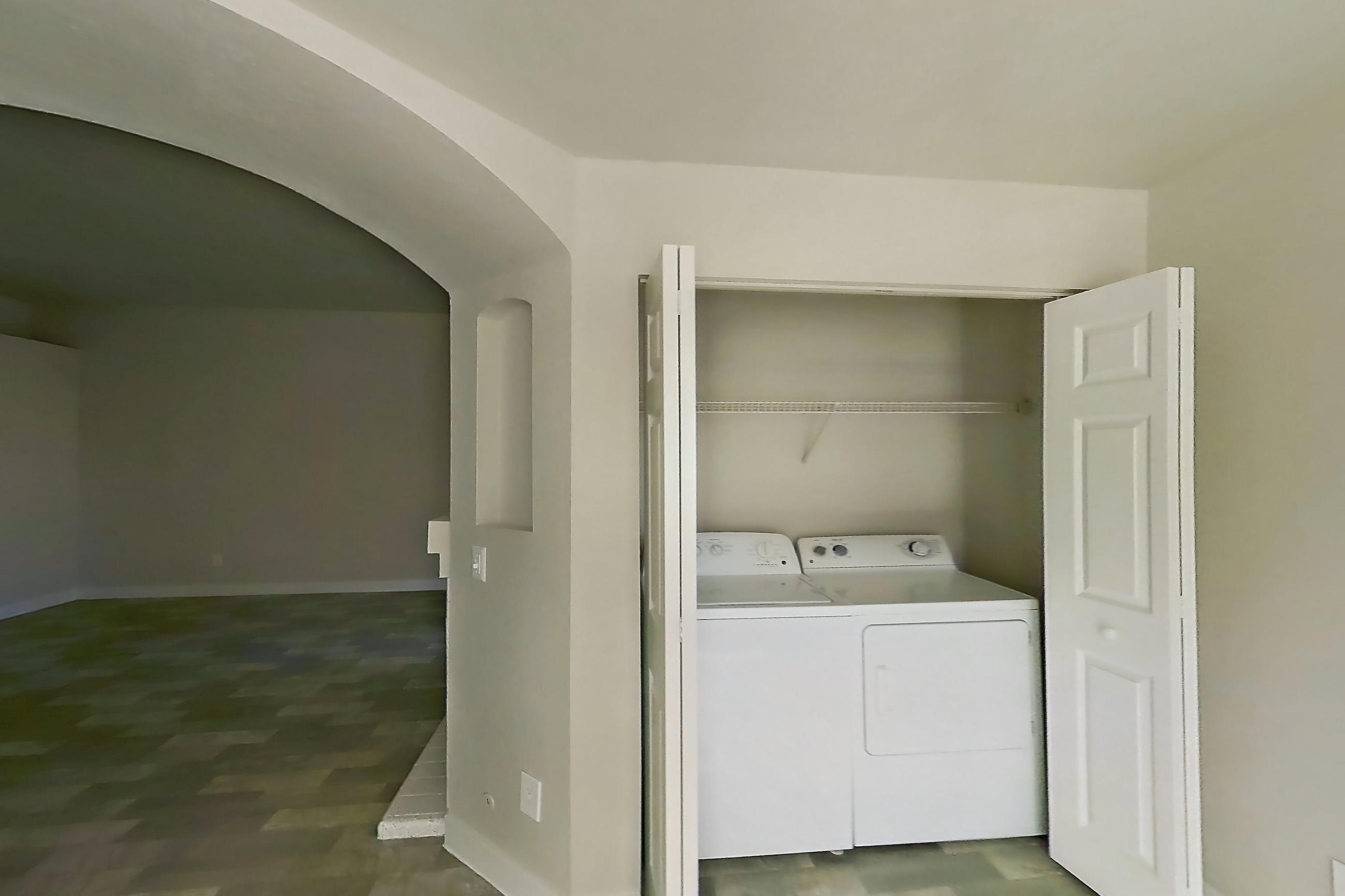 Dining room with in-unit laundry, light countertops, and light wood-finish flooring, Apartment 2004 at Vintage Pointe