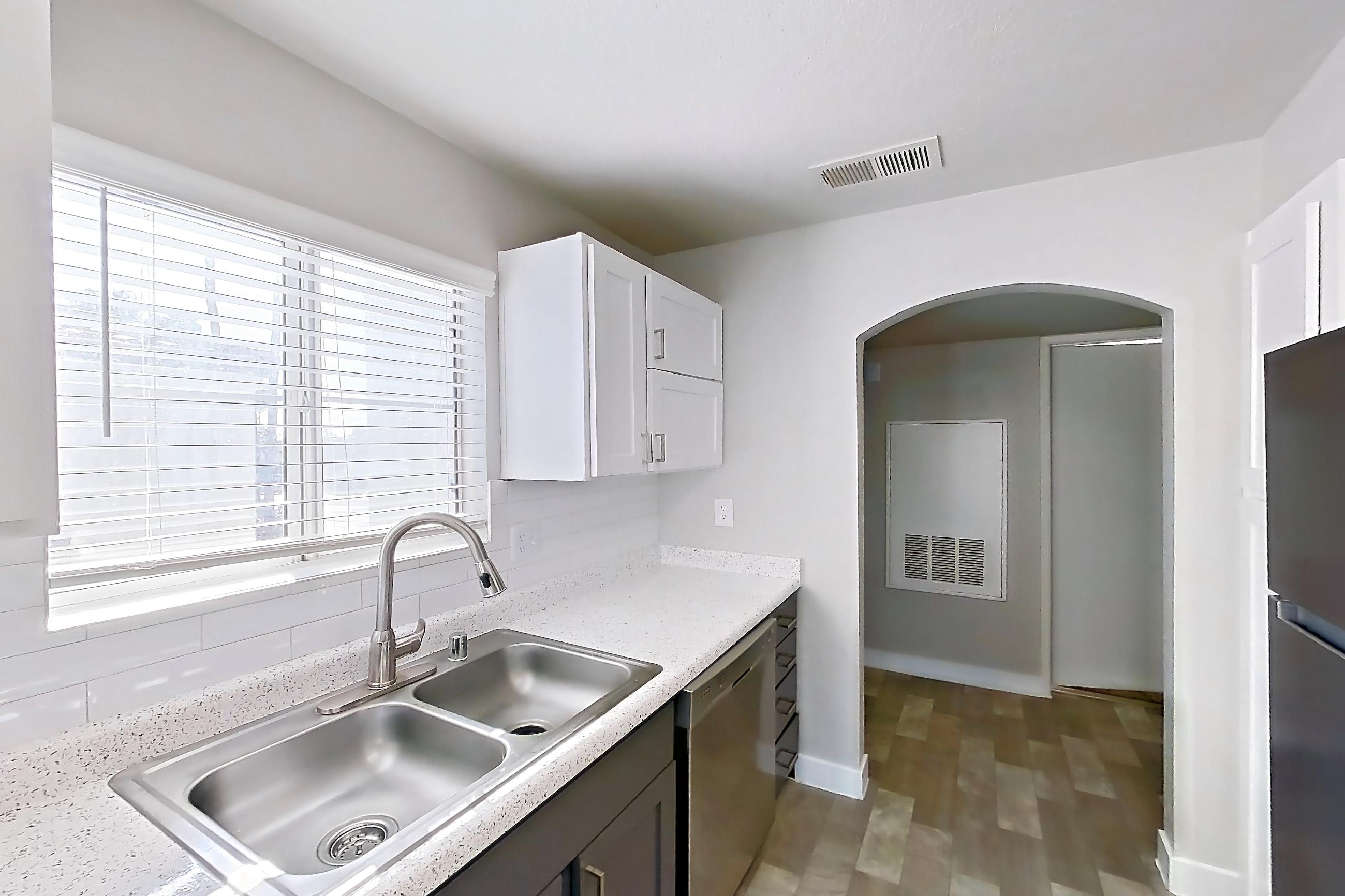 Kitchen with dishwasher, gas range, light countertops, light stone countertops, microwave, oven/range, refrigerator, and stainless steel appliances, Apartment 2004 at Vintage Pointe