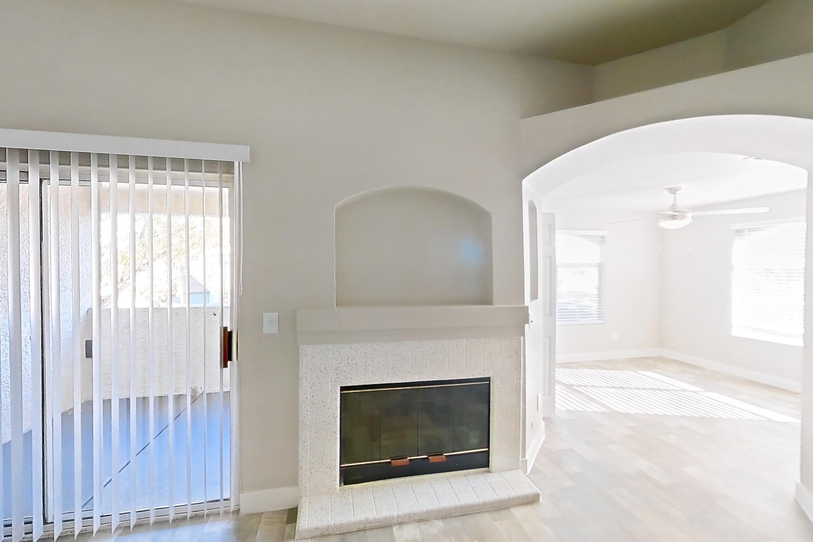 Living room with fireplace, light wood-finish flooring, and tile fireplace, Apartment 2004 at Vintage Pointe