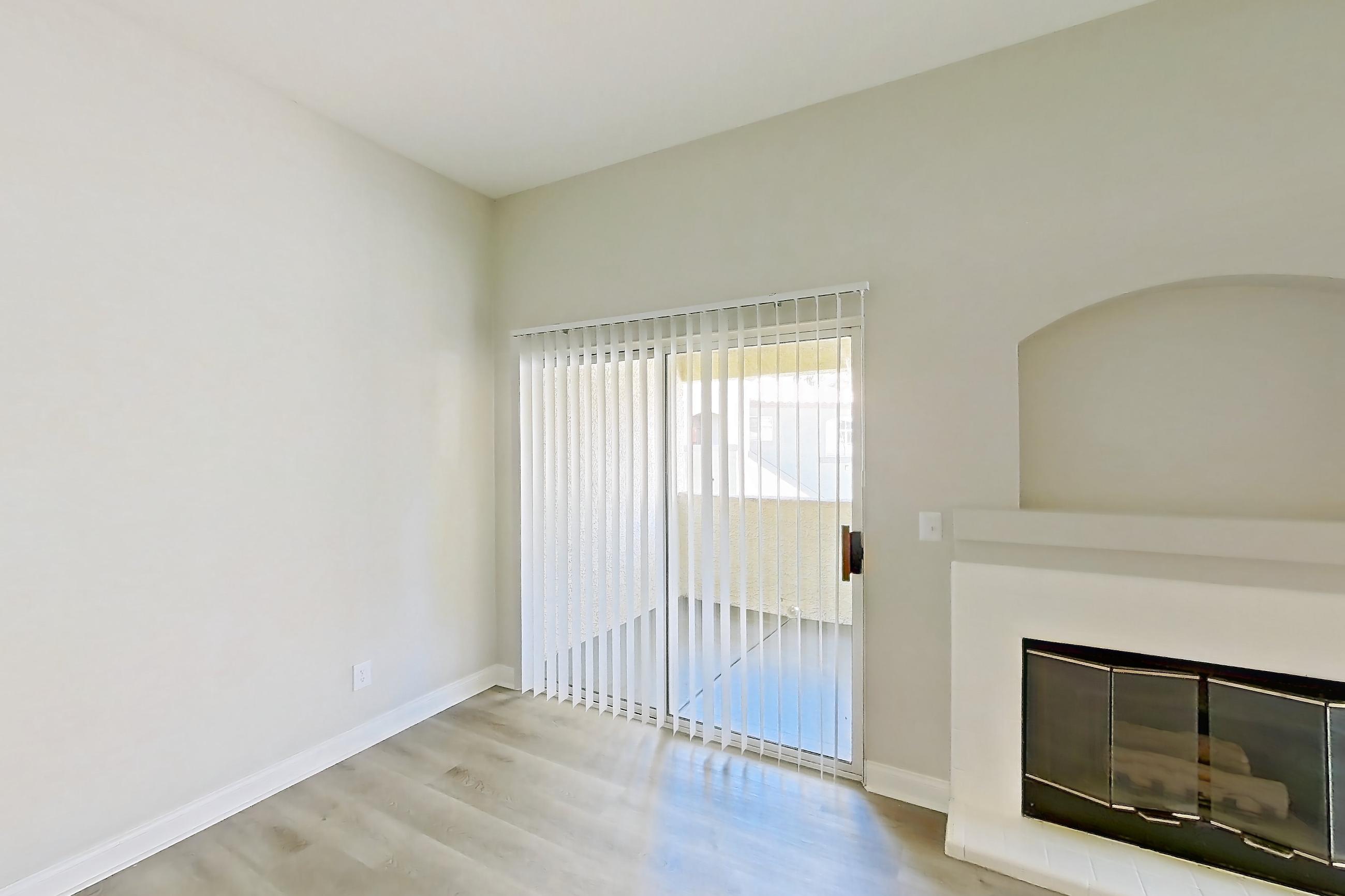 Living room with fireplace and light wood-finish flooring, Apartment 2020 at Vintage Pointe