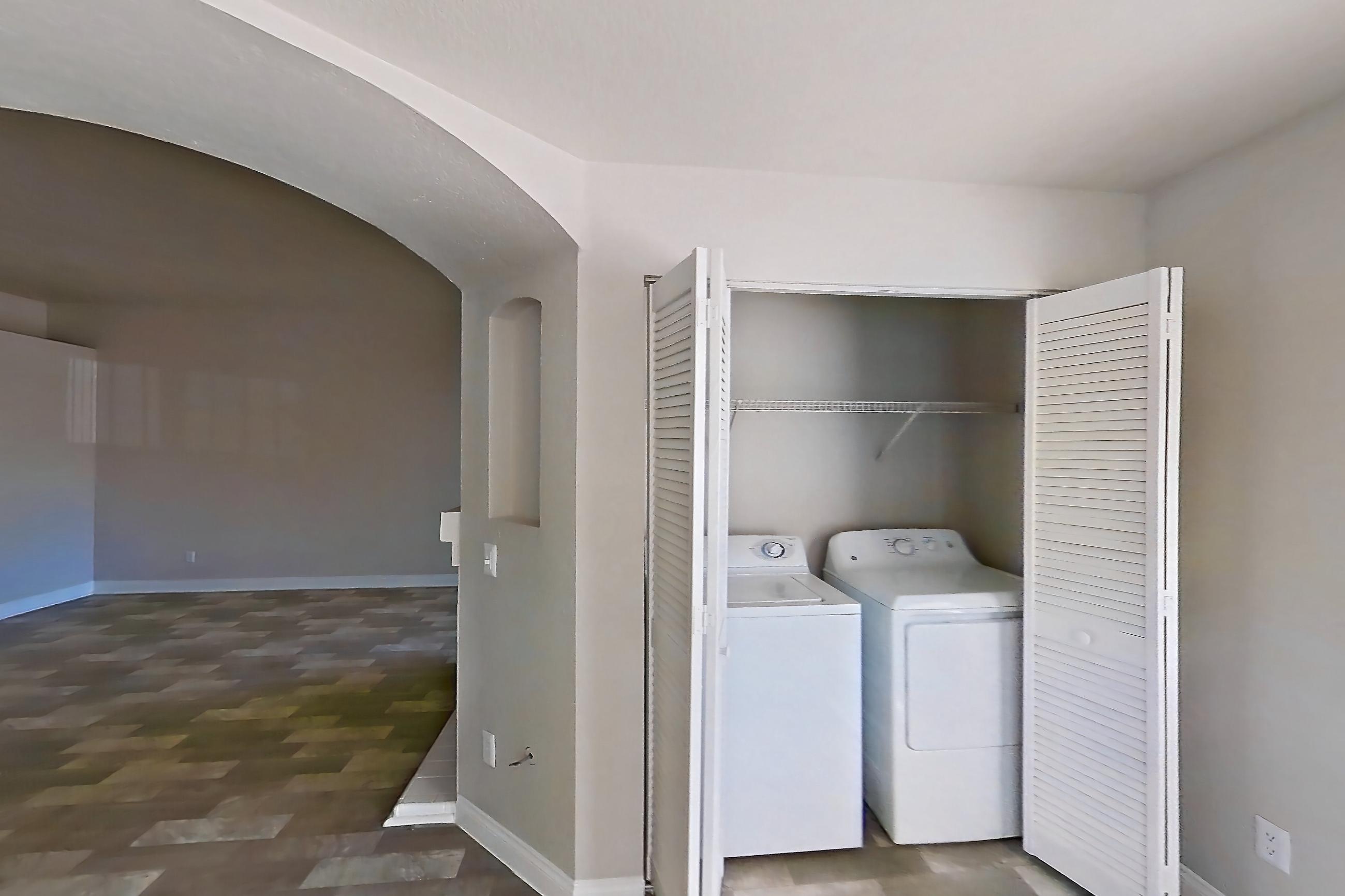 Dining room with in-unit laundry, light countertops, and light wood-finish flooring, Apartment 2042 at Vintage Pointe