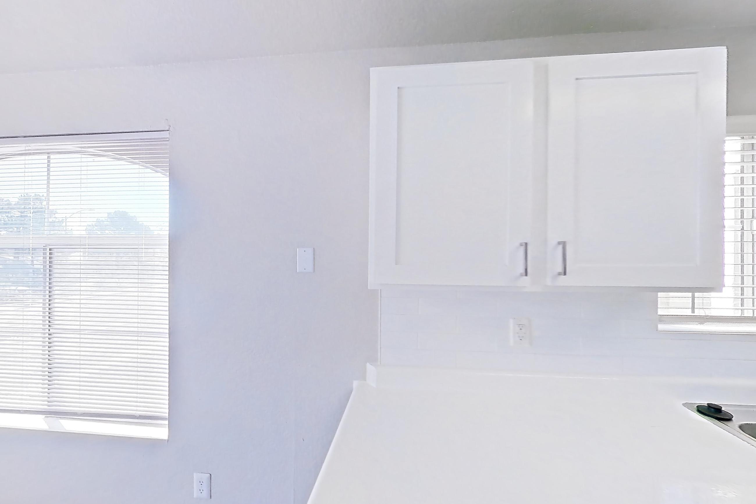 Kitchen with gas range, light countertops, light wood-finish flooring, microwave, oven/range, refrigerator, and stainless steel appliances, Apartment 2042 at Vintage Pointe