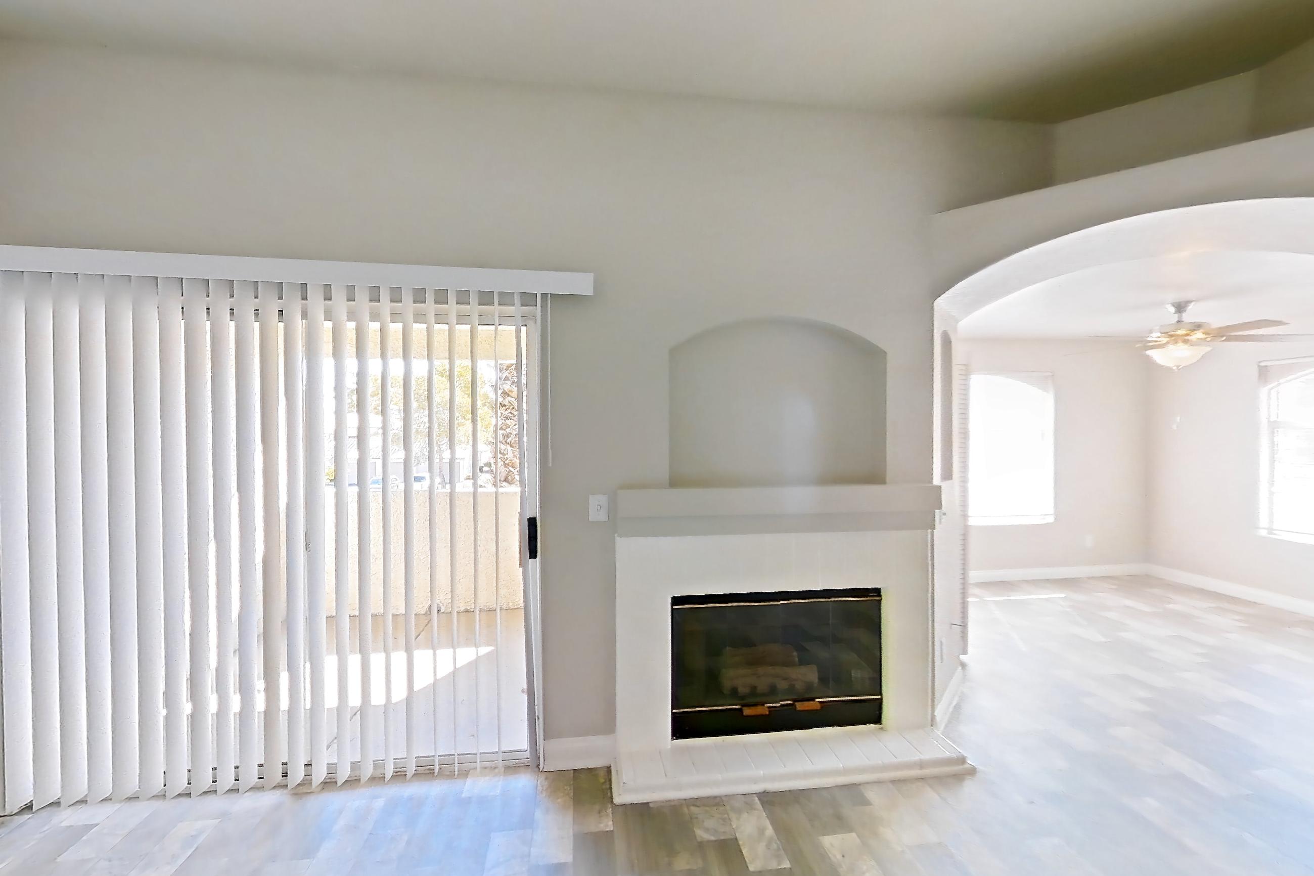 Living room with fireplace and light wood-finish flooring, Apartment 2042 at Vintage Pointe