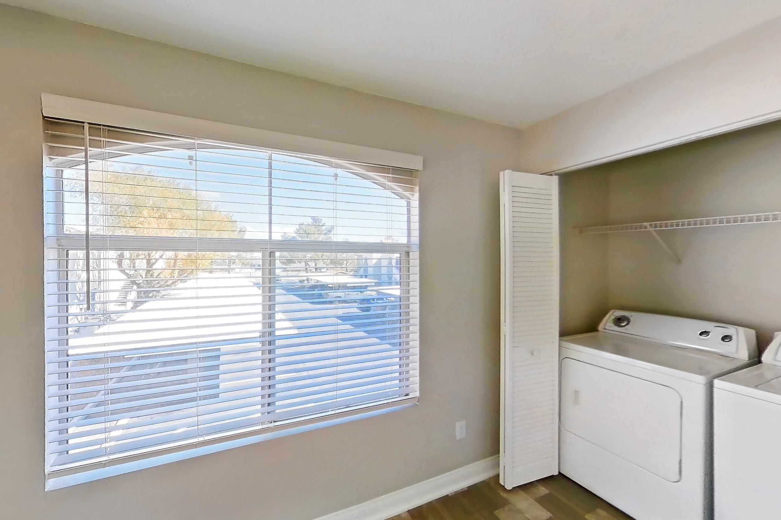 Dining room with dark wood-finish flooring, in-unit laundry, light countertops, and light wood-finish flooring, Apartment 2081 at Vintage Pointe