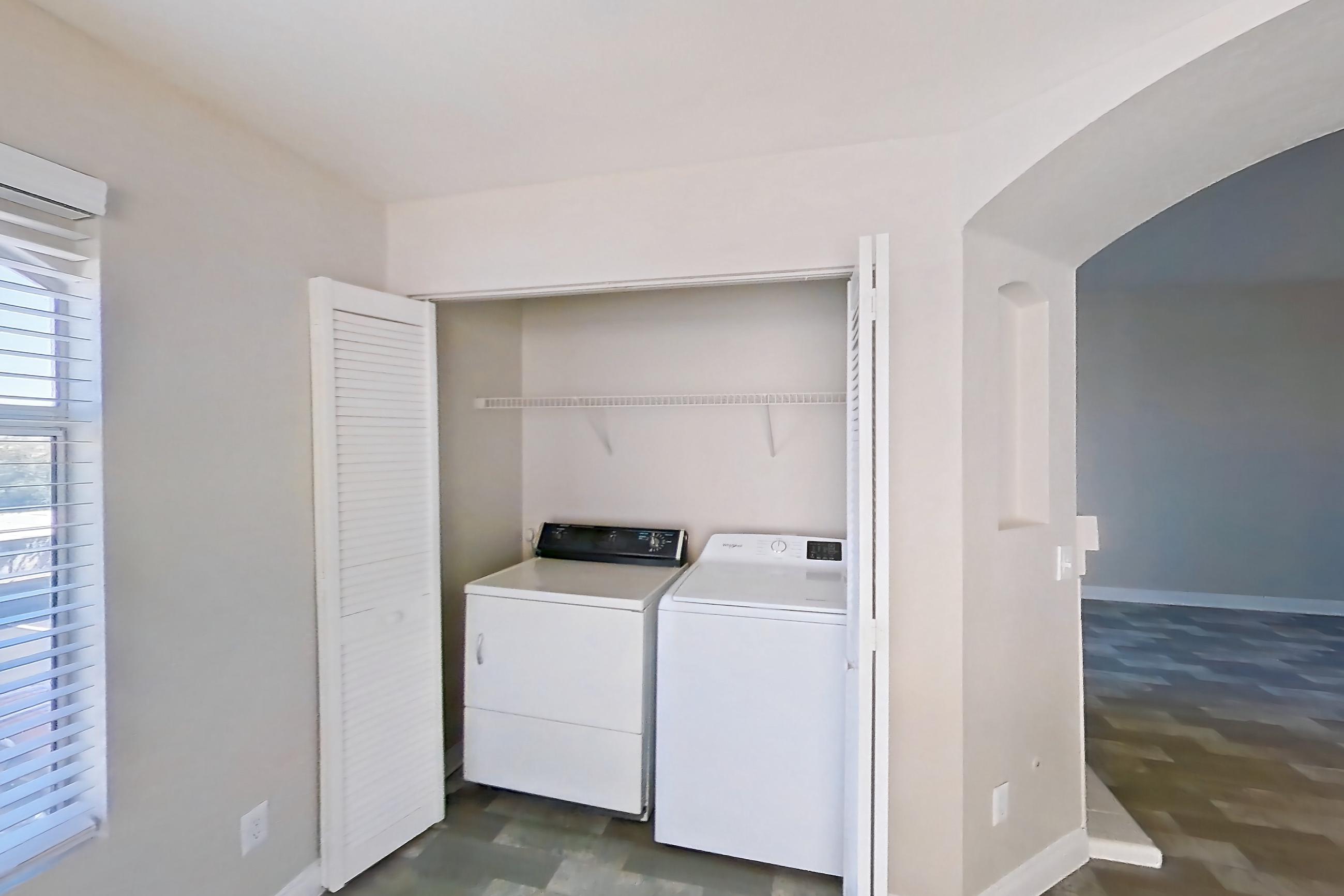 Dining room with dark wood-finish flooring, in-unit laundry, light countertops, and light wood-finish flooring, Apartment 2089 at Vintage Pointe