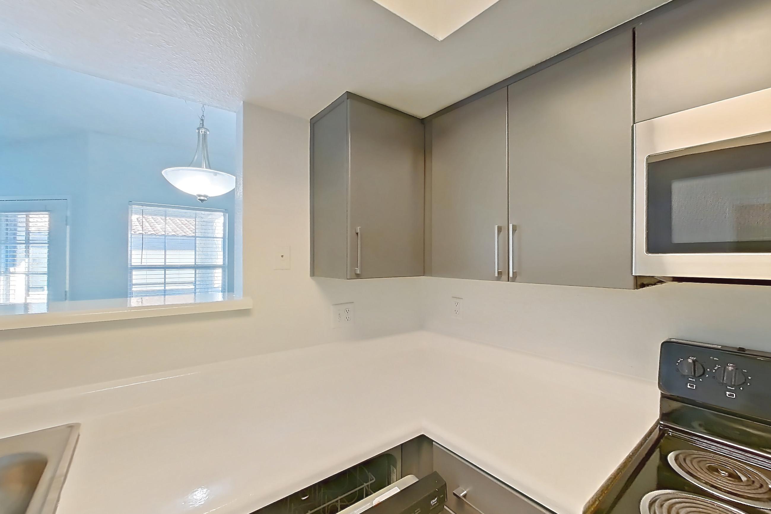 Kitchen with dishwasher, electric range, light countertops, light wood-finish flooring, microwave, oven/range, and stainless steel appliances, Apartment 2091 at The Met Las Vegas