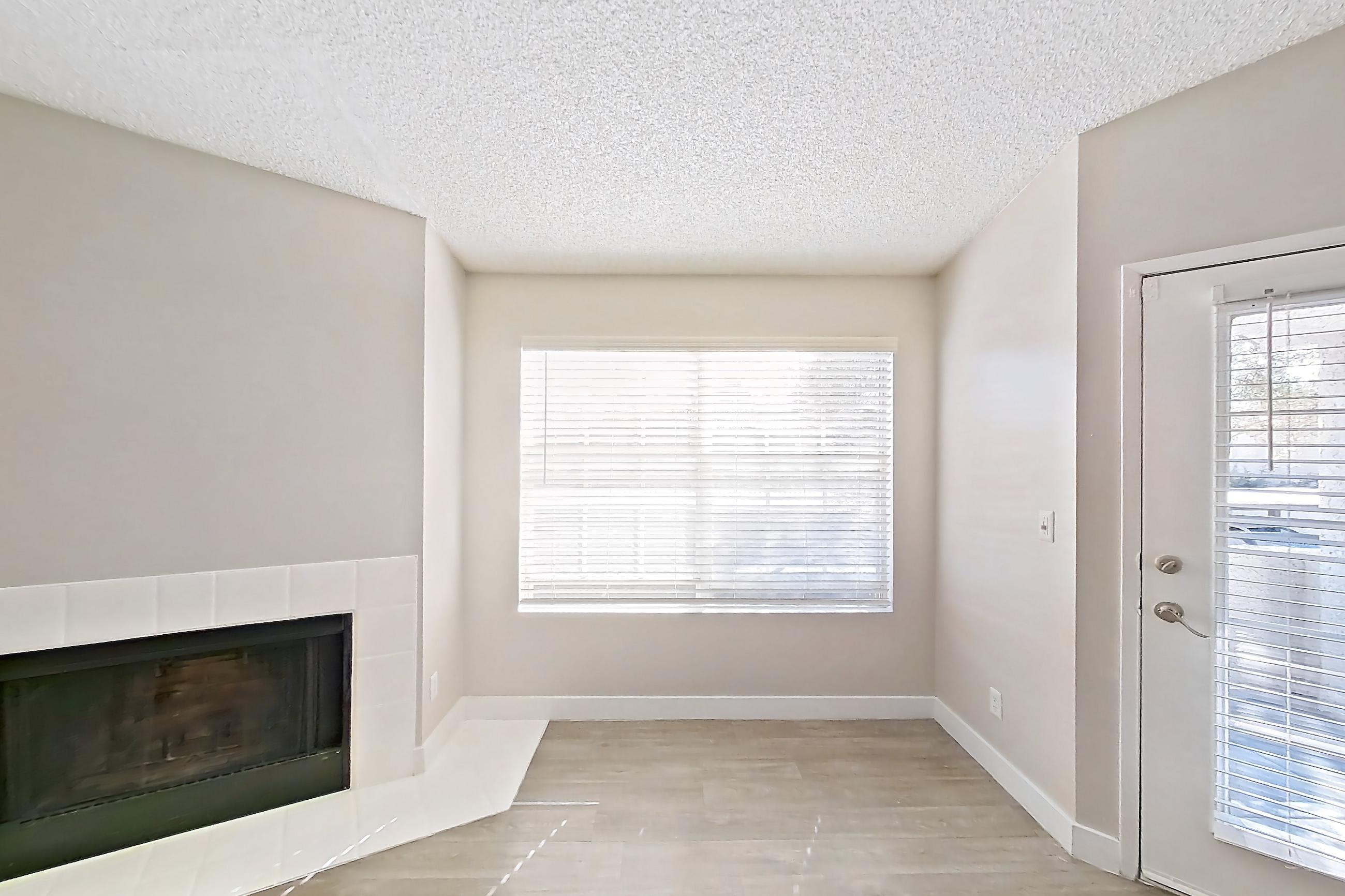 Living room with fireplace, light wood-finish flooring, and tile fireplace, Apartment 2233 at The Met Las Vegas