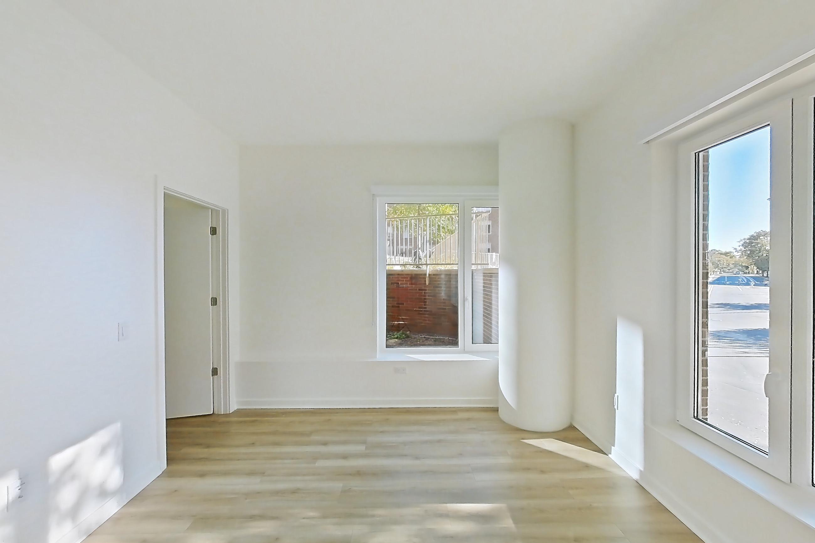 Living room with light wood-finish flooring, Apartment 112 at Residences at Mazza