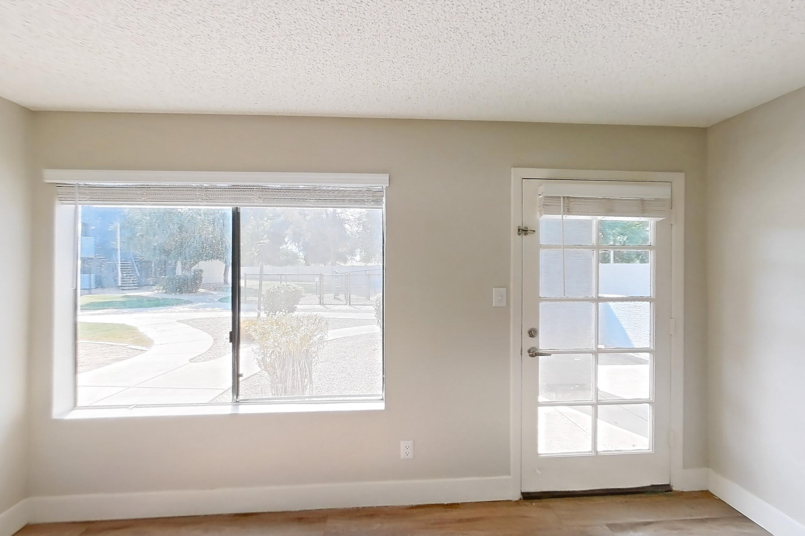 Living room with light wood-finish flooring, Apartment B-1023 at Arches at Hidden Creek