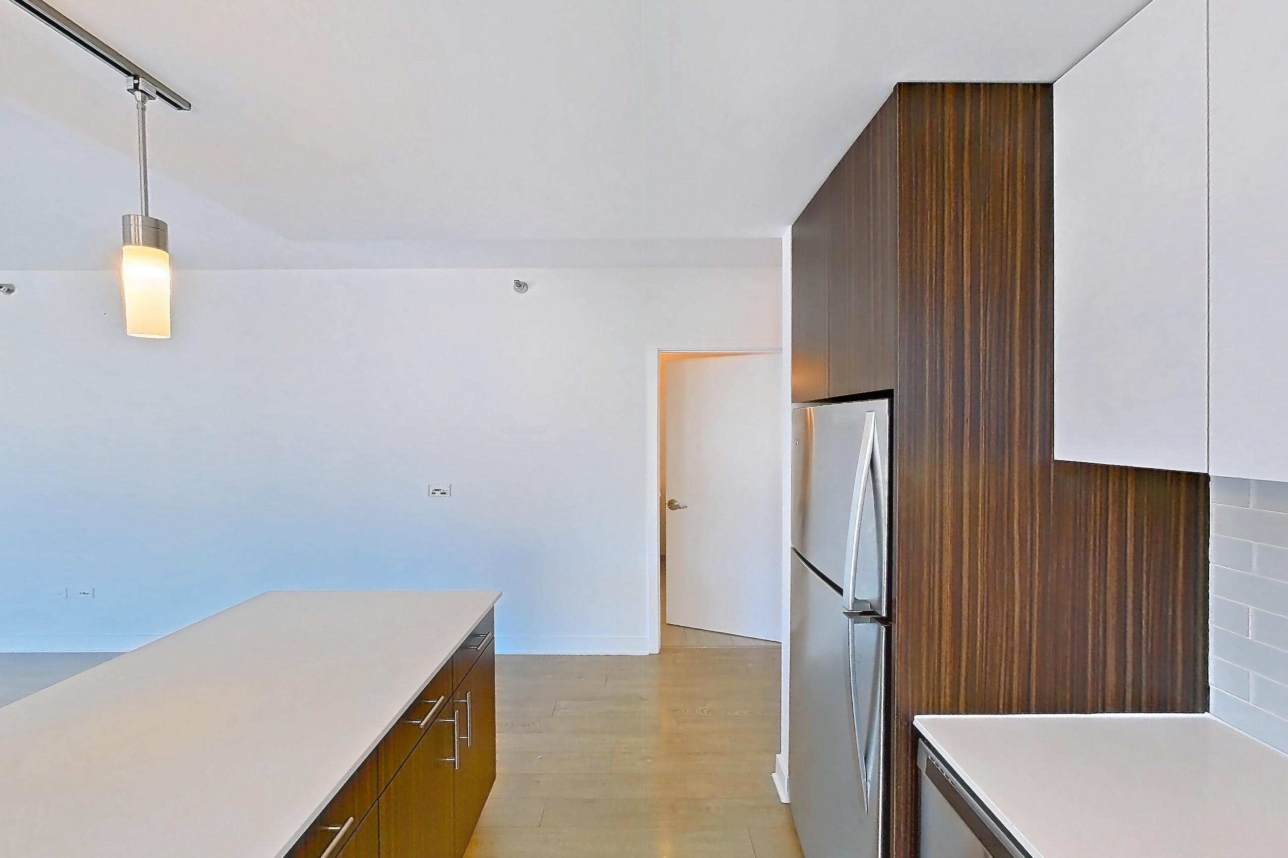 Kitchen with dishwasher, gas range, light countertops, light wood-finish flooring, oven/range, and stainless steel appliances, Apartment 3104 at Mila