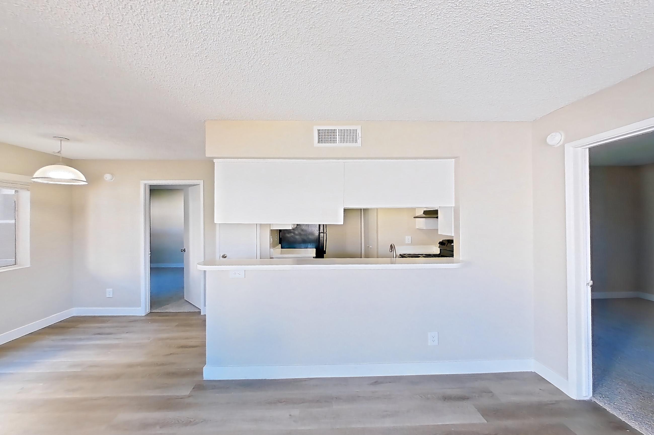 Living room with fireplace, light wood-finish flooring, oven/range, refrigerator, tile fireplace, and white appliances, Apartment 2079 at Terra Vida Apartments