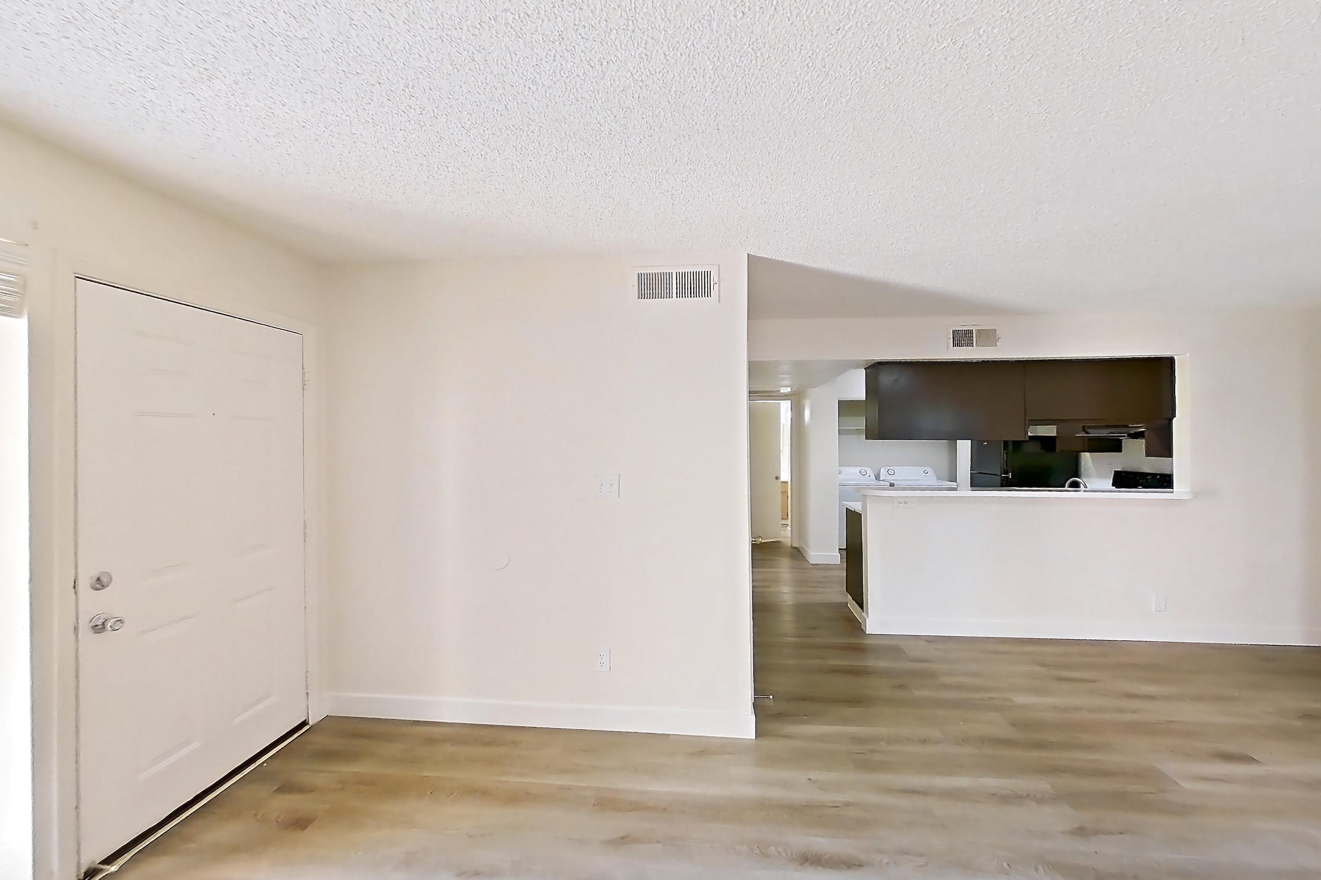Living room with light wood-finish flooring, Apartment 1061 at Terra Vida Apartments