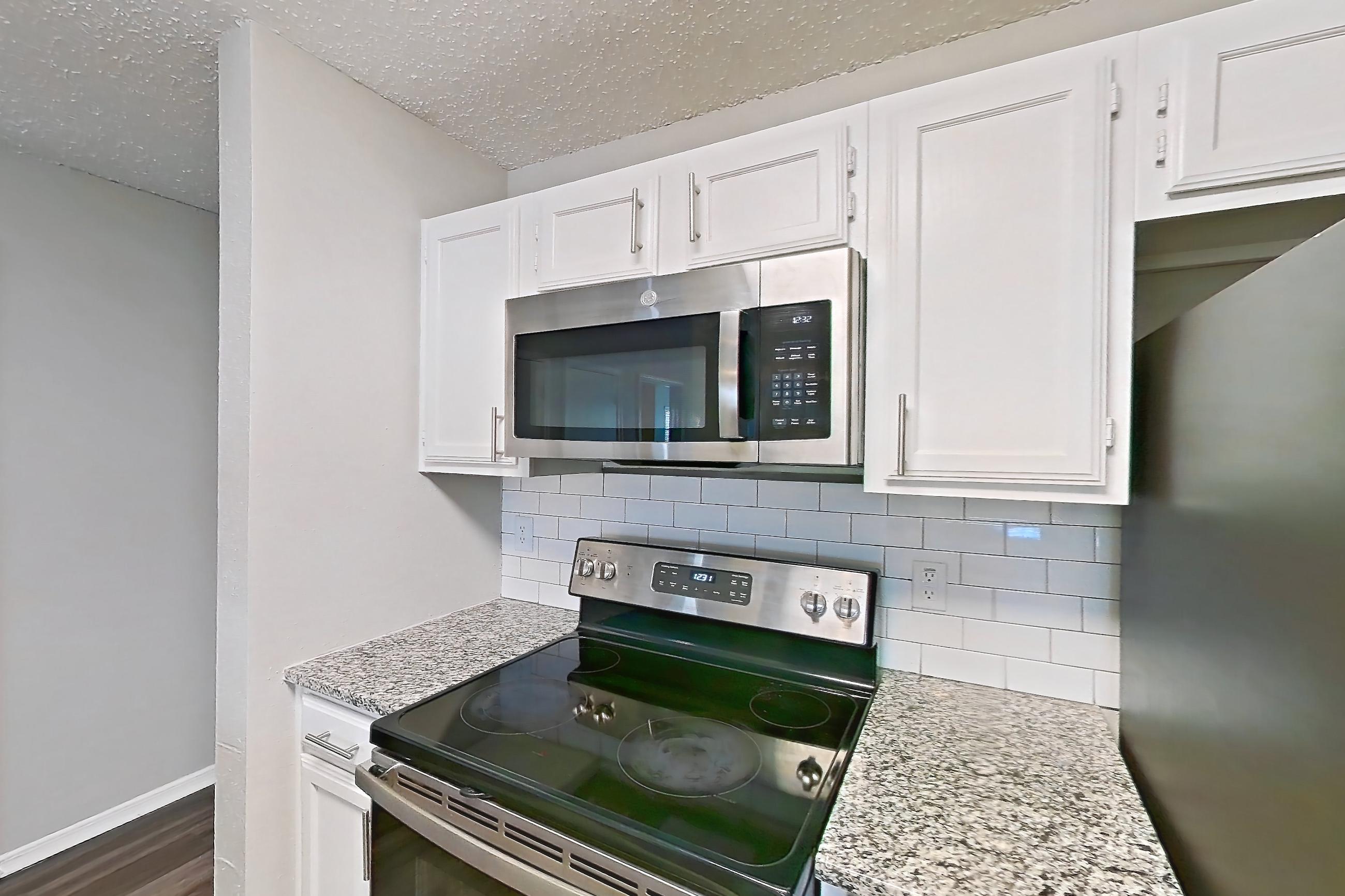Kitchen in Apartment 13-1332 at The Arbors of Las Colinas, 2B floor plan