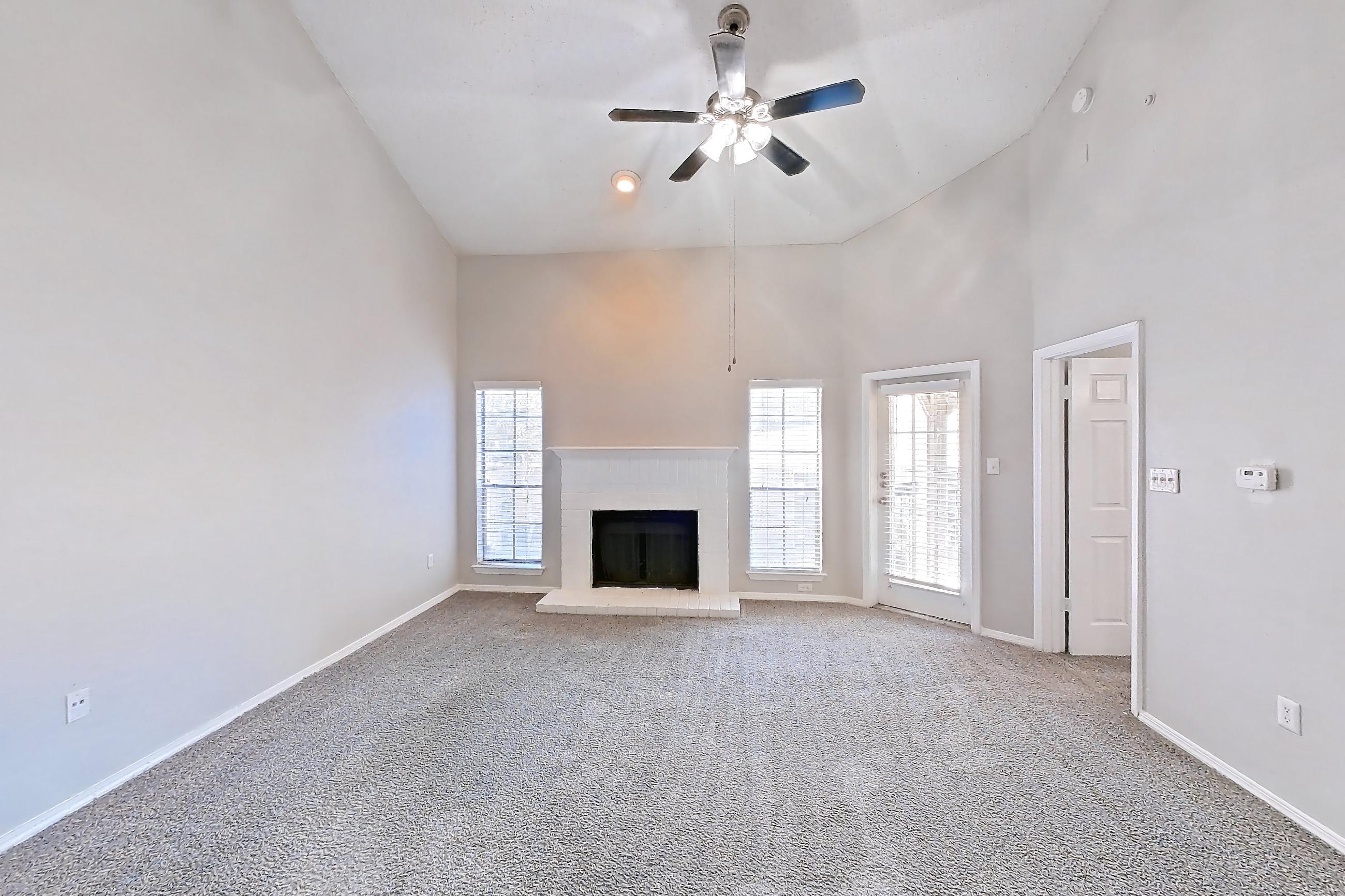 Dining room with brick fireplace and fireplace, Apartment 08-0821 at The Arbors of Las Colinas