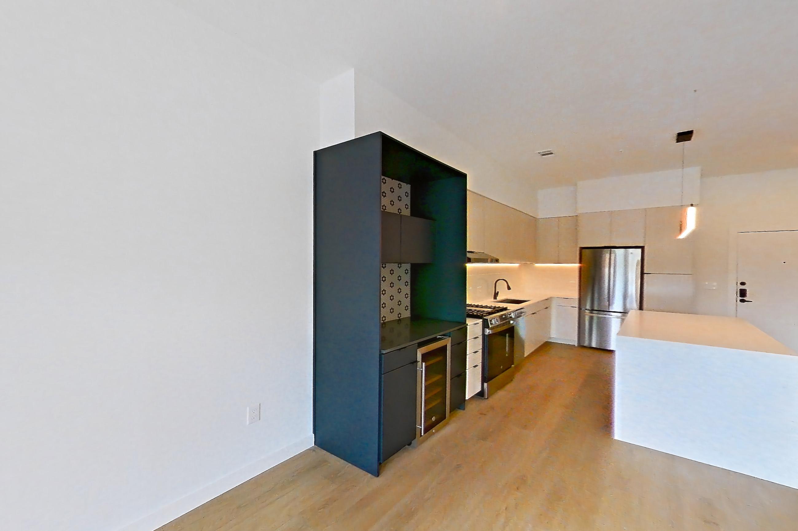 Living room with gas range, light stone countertops, light wood-finish flooring, oven/range, refrigerator, and stainless steel appliances, Apartment 0211 at Tempo at White Oak