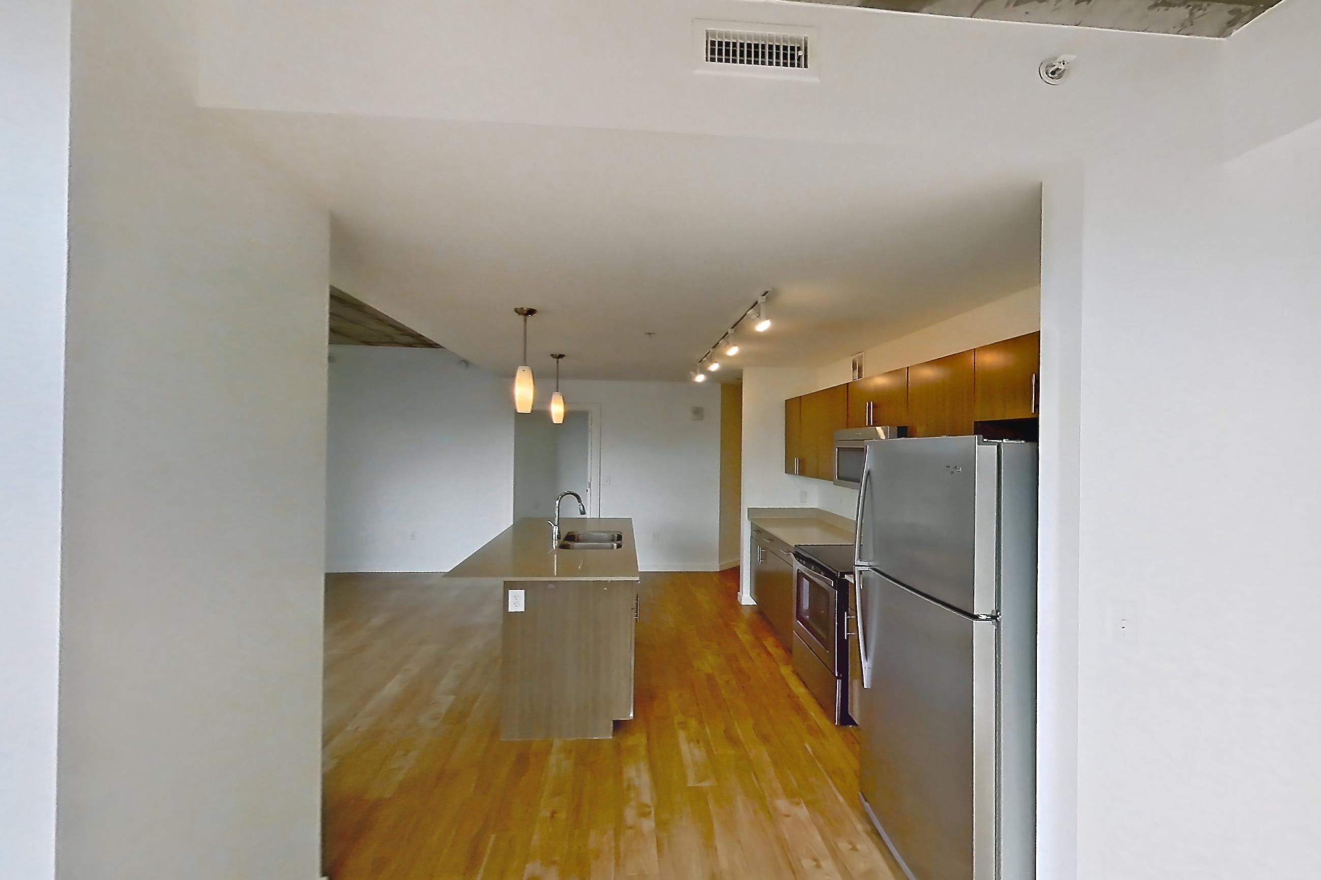 Dining room with kitchen island, light countertops, and light wood-finish flooring, Apartment 1230 at Cadence at Union Station
