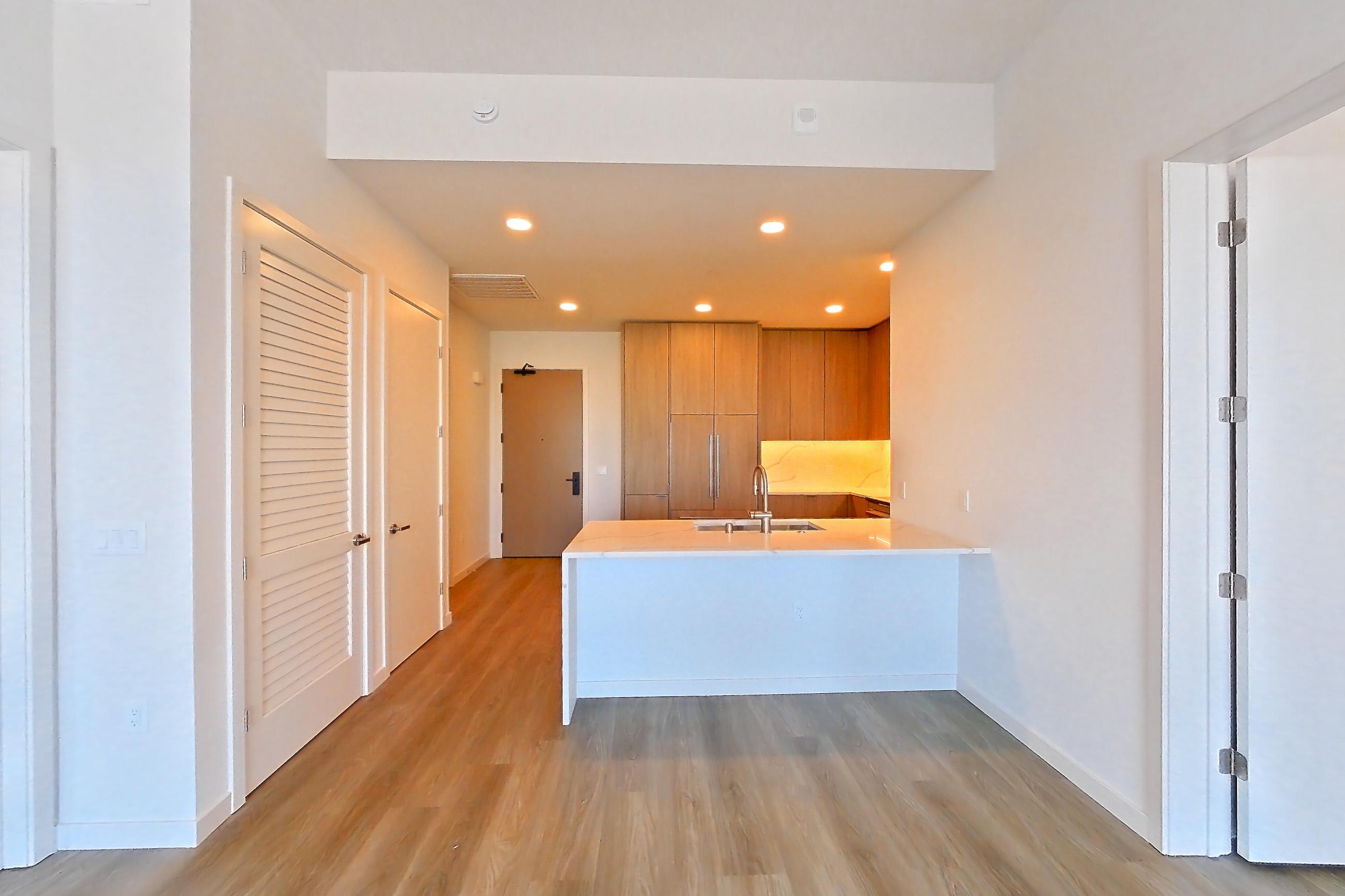 Living room with light stone countertops and light wood-finish flooring, Apartment 816 at Revery