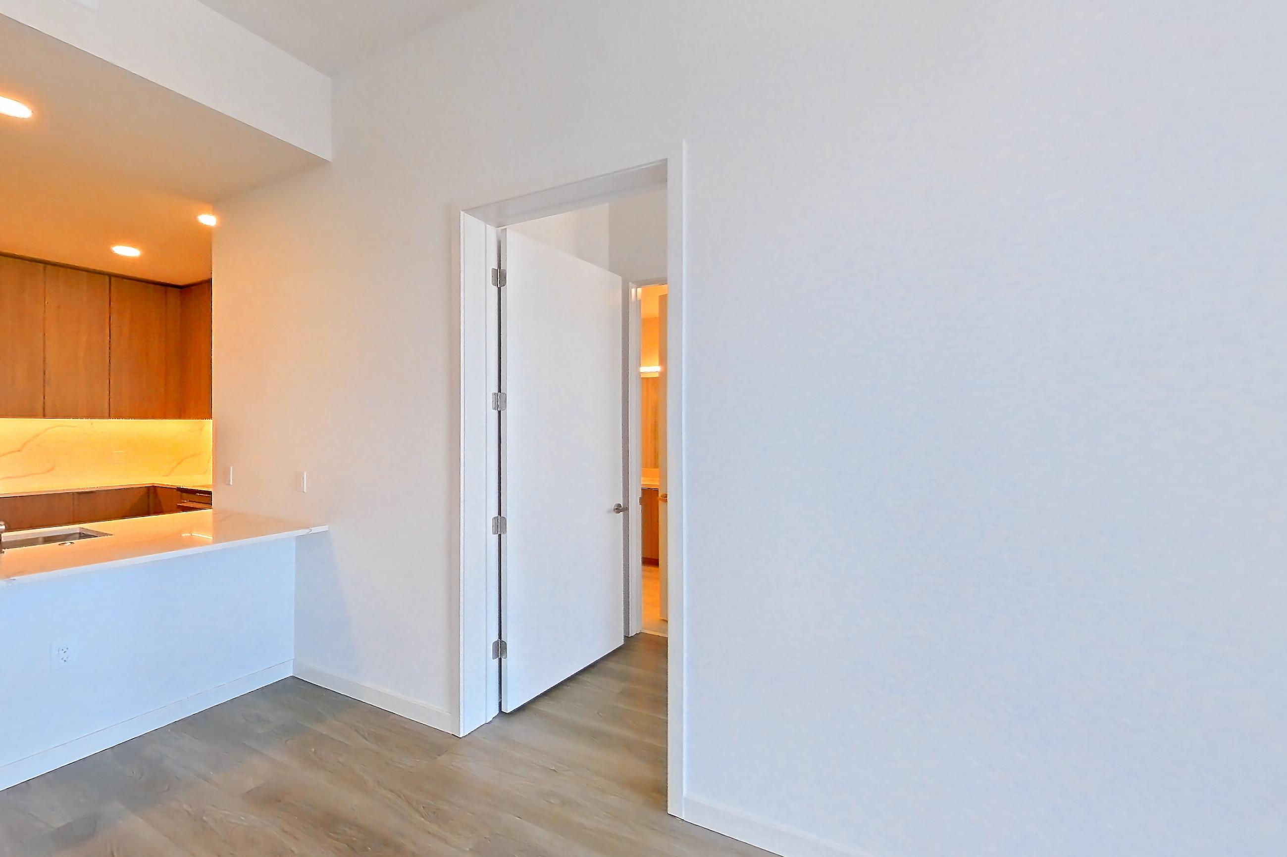 Living room with light stone countertops and light wood-finish flooring, Apartment 816 at Revery