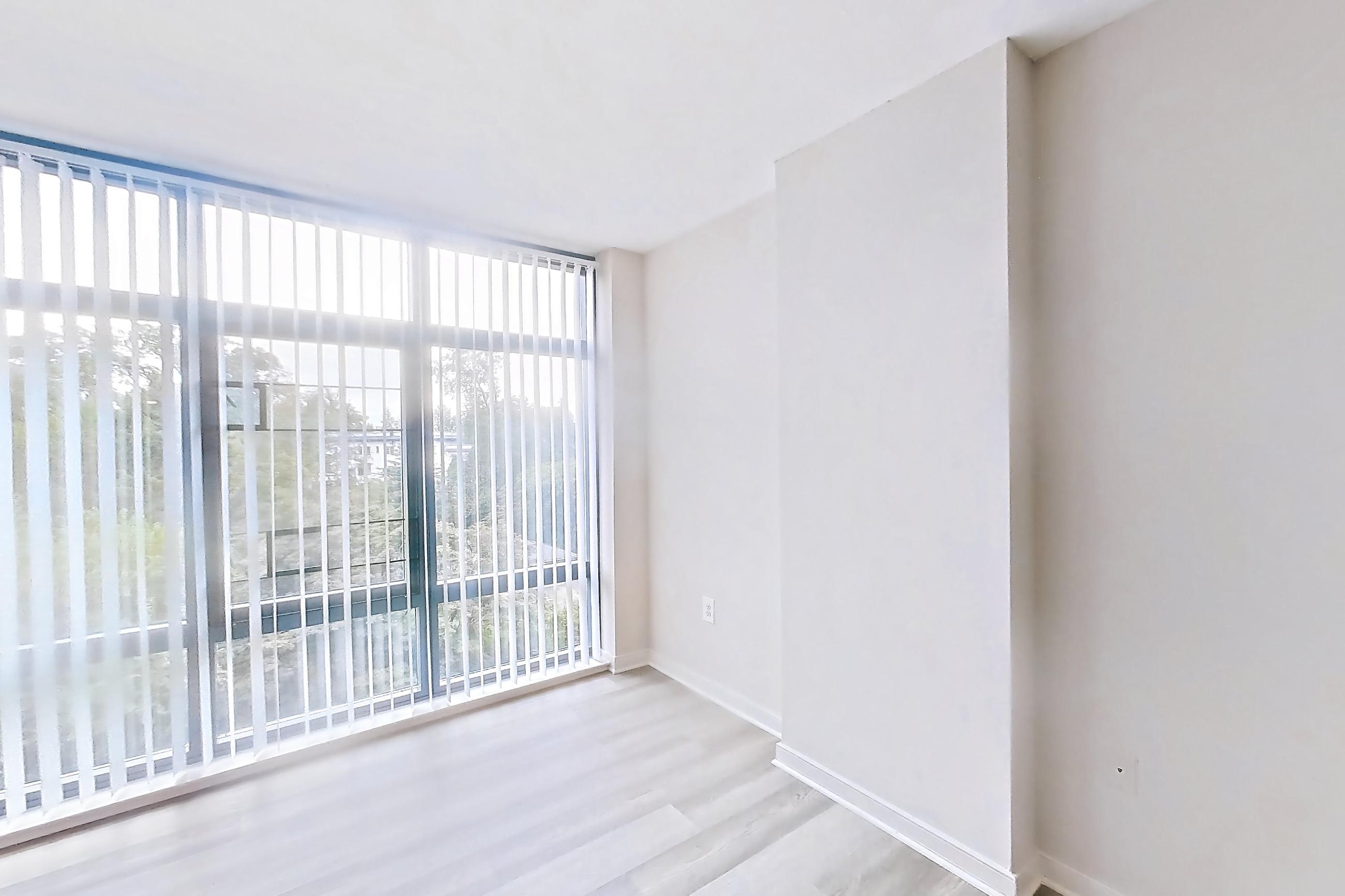 Living space with light wood-finish flooring, Apartment 617 at The Barton at Woodley