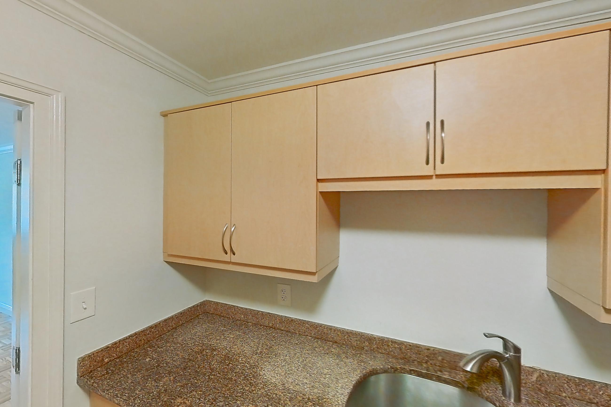 Kitchen with dark stone countertops, dishwasher, electric range, light tile flooring, light wood-finish flooring, oven/range, parquet flooring, refrigerator, and stainless steel appliances, Apartment 199-0208 at Church Park