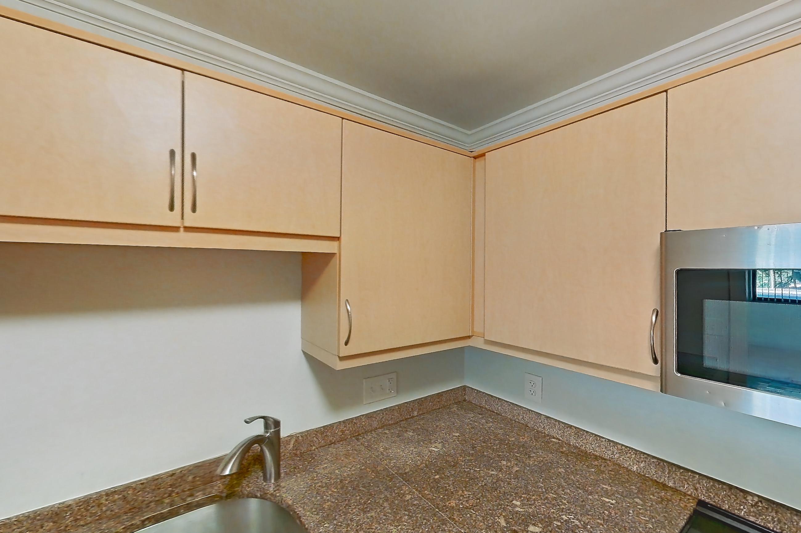 Kitchen with dark stone countertops, dishwasher, electric range, light tile flooring, light wood-finish flooring, oven/range, parquet flooring, refrigerator, and stainless steel appliances, Apartment 199-0208 at Church Park