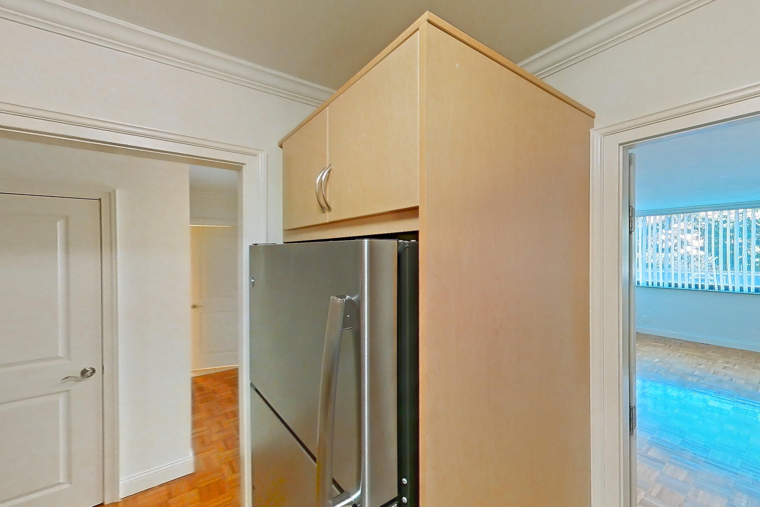 Kitchen with dark stone countertops, dishwasher, electric range, light tile flooring, light wood-finish flooring, oven/range, parquet flooring, refrigerator, and stainless steel appliances, Apartment 199-0208 at Church Park
