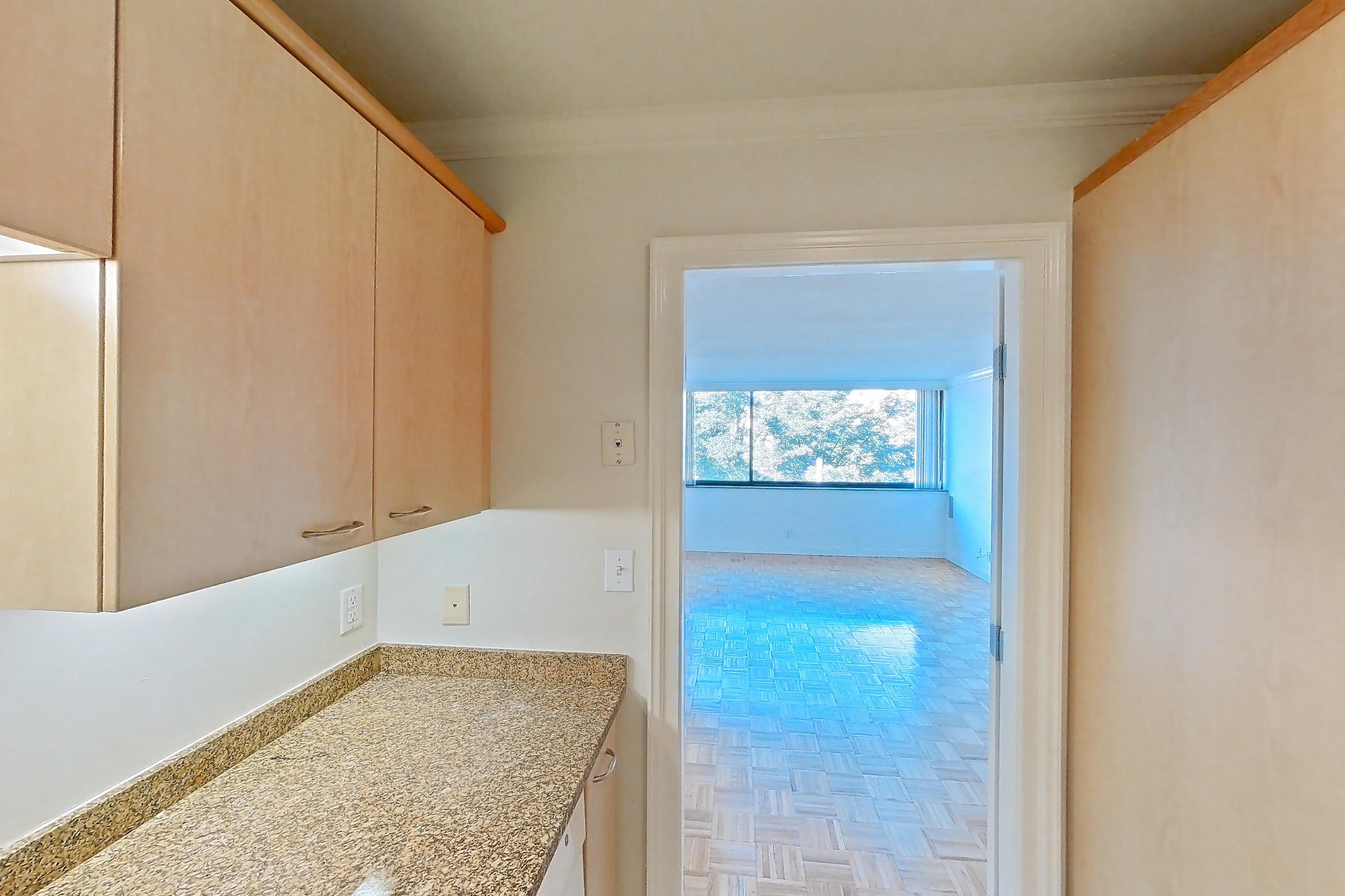 Kitchen with dark stone countertops, dishwasher, electric range, light stone countertops, light tile flooring, light wood-finish flooring, oven/range, parquet flooring, refrigerator, and white appliances, Apartment 199-0304 at Church Park