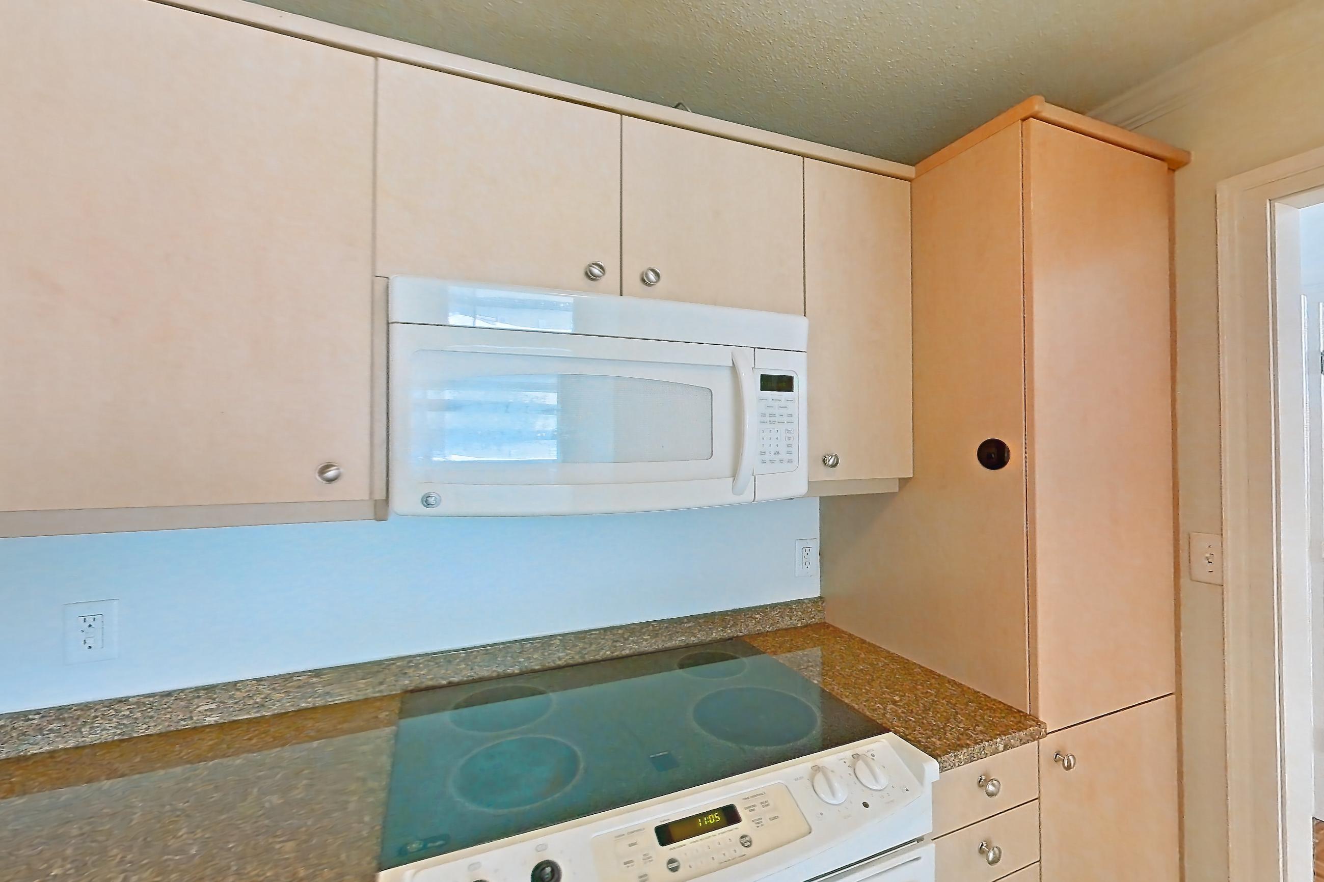 Kitchen with dark stone countertops, electric range, light tile flooring, oven/range, and white appliances, Apartment 255-0216 at Church Park