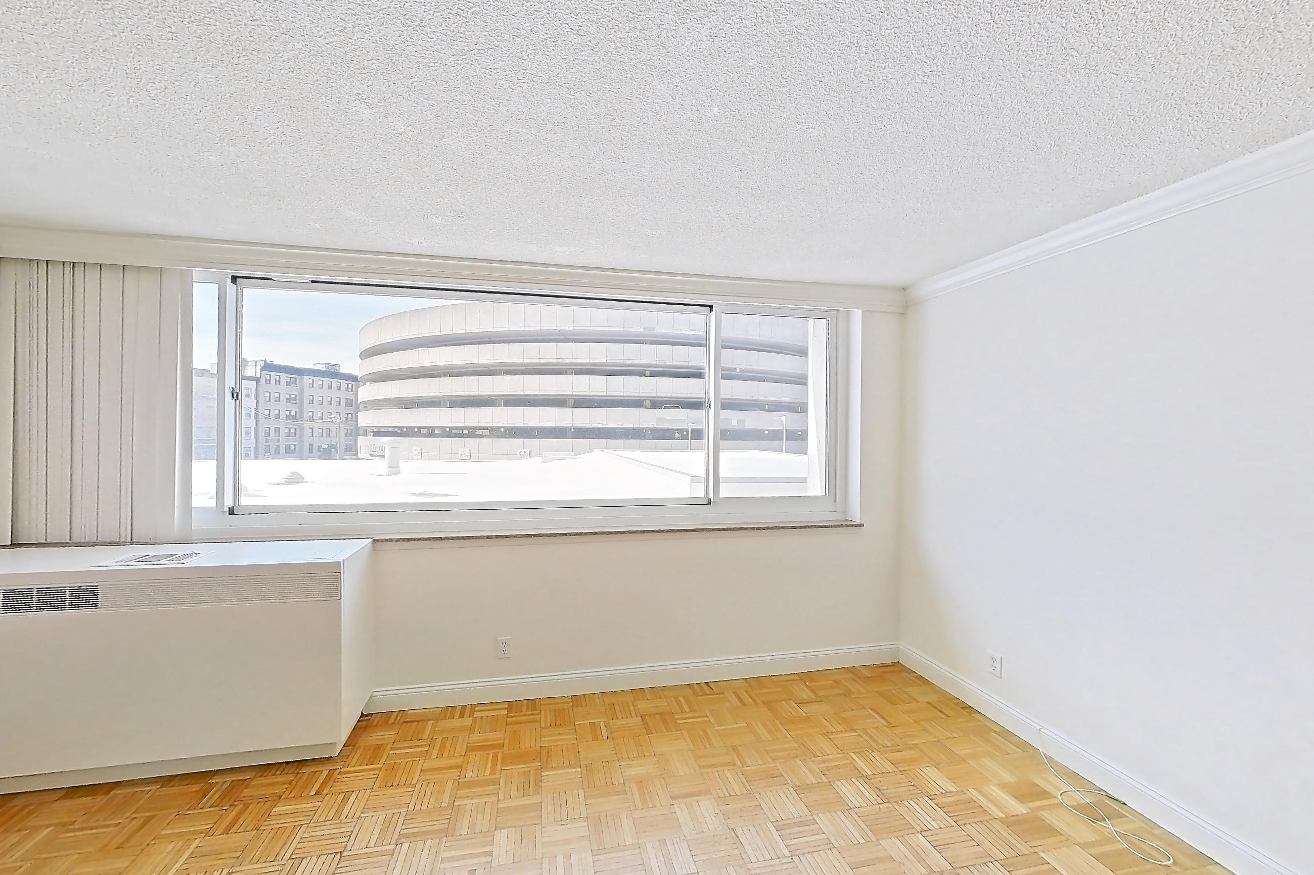 Living room with light wood-finish flooring and parquet flooring, Apartment 255-0216 at Church Park