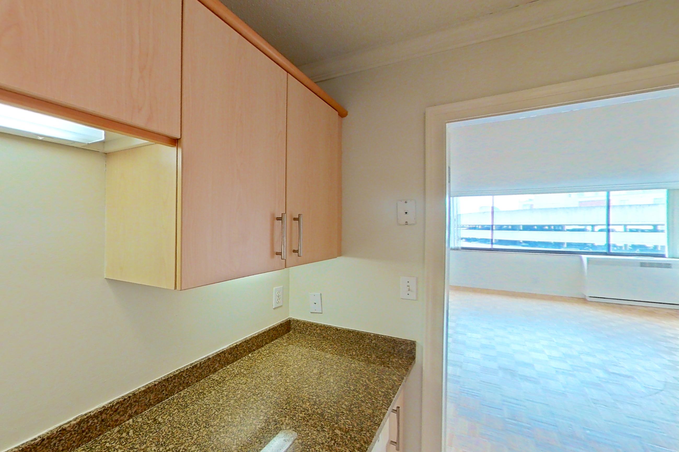 Kitchen with dark stone countertops, electric range, light tile flooring, oven/range, and white appliances, Apartment 255-0514 at Church Park