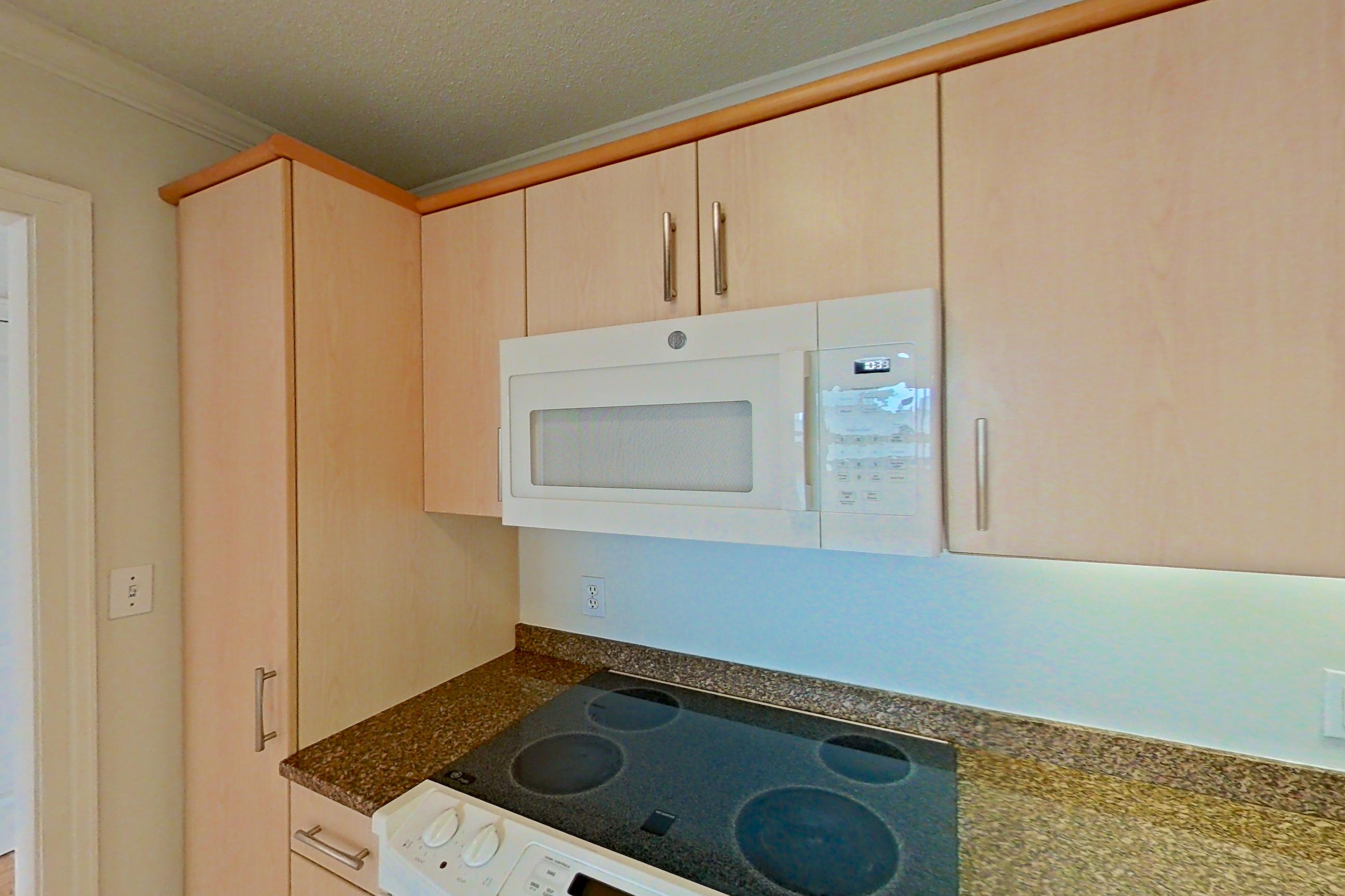 Kitchen with dark stone countertops, electric range, light tile flooring, oven/range, and white appliances, Apartment 255-0514 at Church Park
