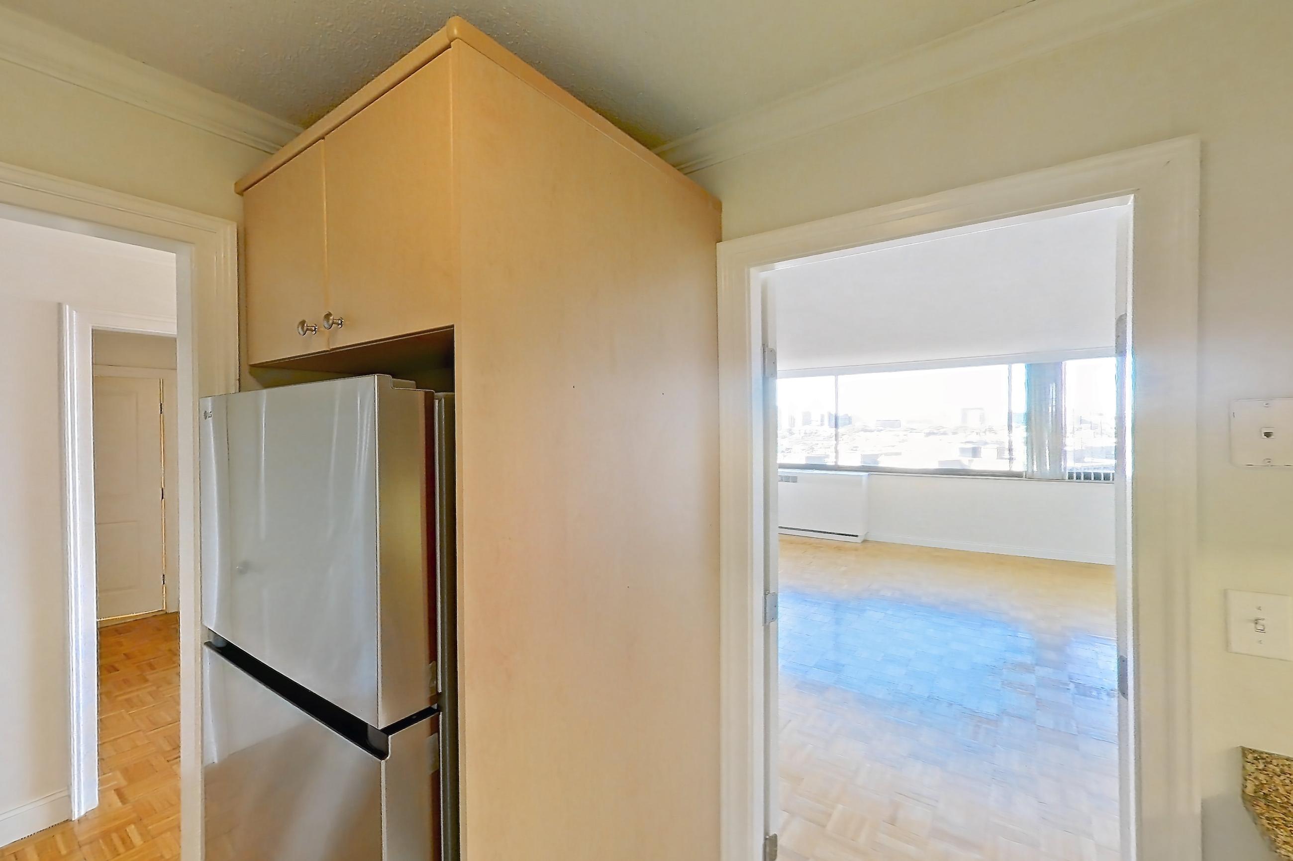 Kitchen with dishwasher, electric range, light stone countertops, light tile flooring, light wood-finish flooring, microwave, oven/range, and white appliances, Apartment 255-0906 at Church Park