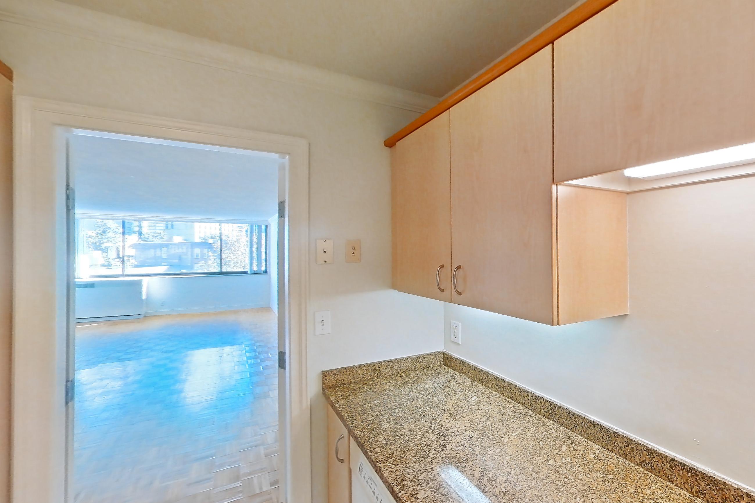 Kitchen with dishwasher, electric range, light stone countertops, light tile flooring, light wood-finish flooring, oven/range, parquet flooring, and white appliances, Apartment 199-0411 at Church Park