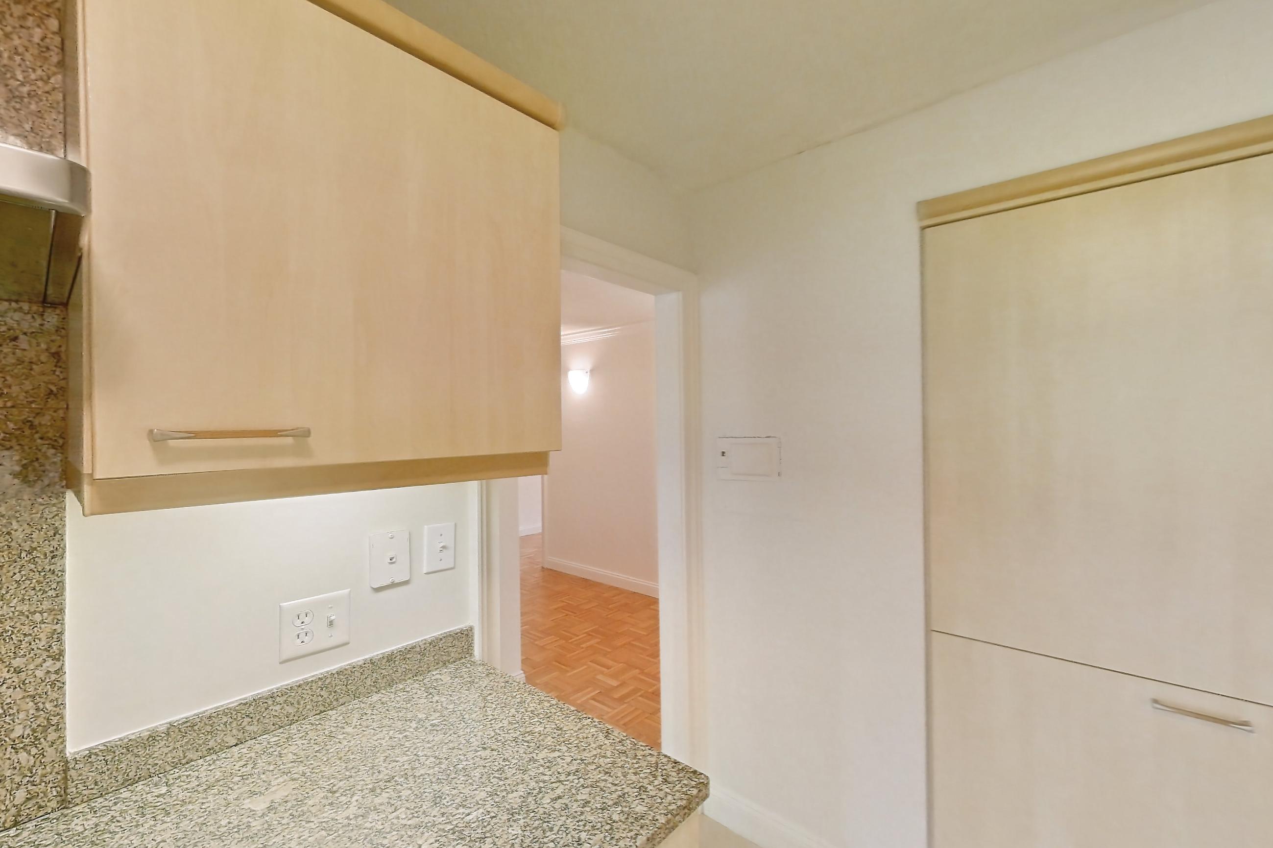 Kitchen with black appliances, cooktop, electric cooktop, light stone countertops, light tile flooring, oven/range, and range hood, Apartment 255-0318 at Church Park