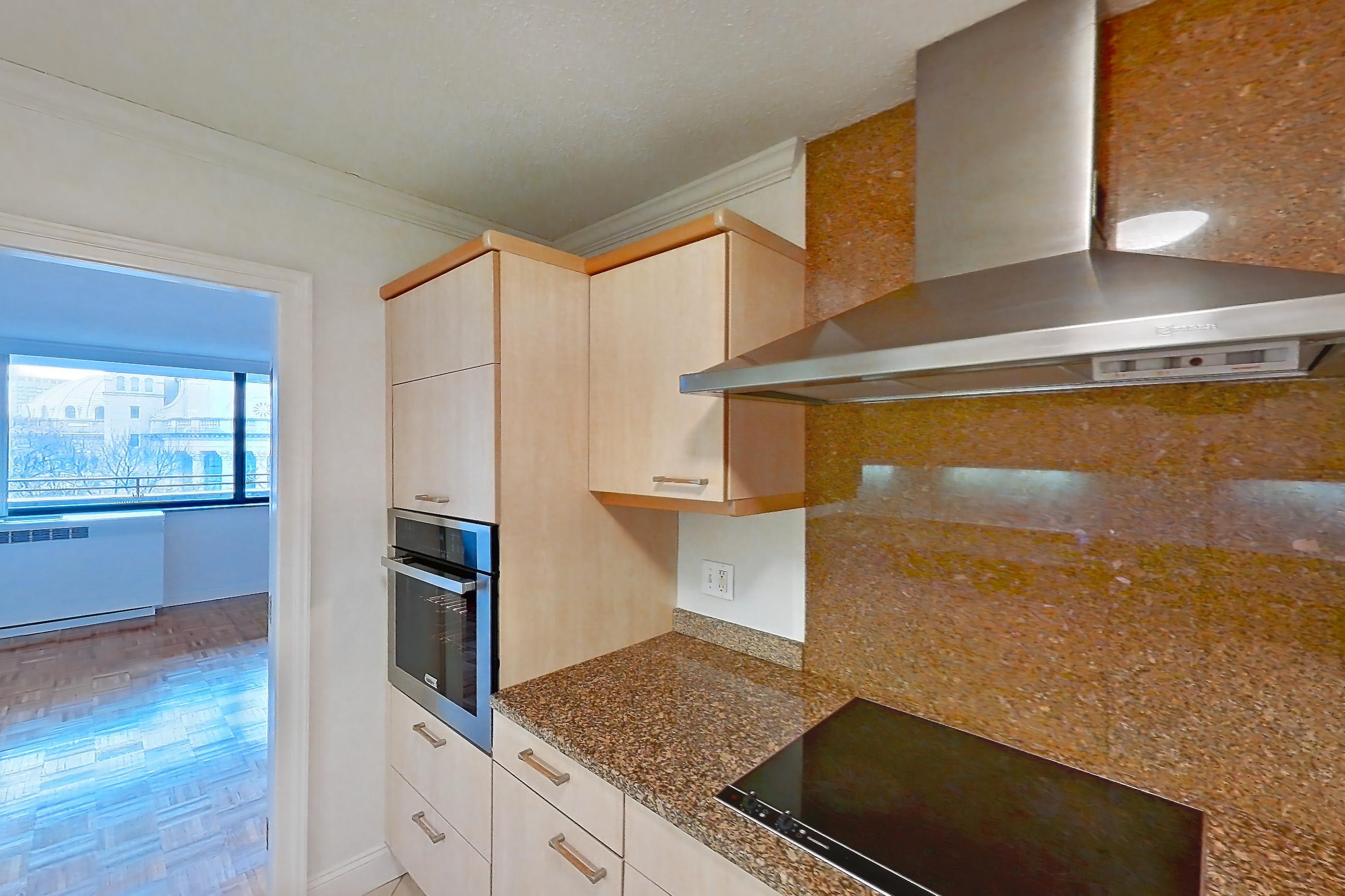 Kitchen with black appliances, cooktop, dark stone countertops, electric cooktop, light stone countertops, light tile flooring, and range hood, Apartment 255-0518 at Church Park