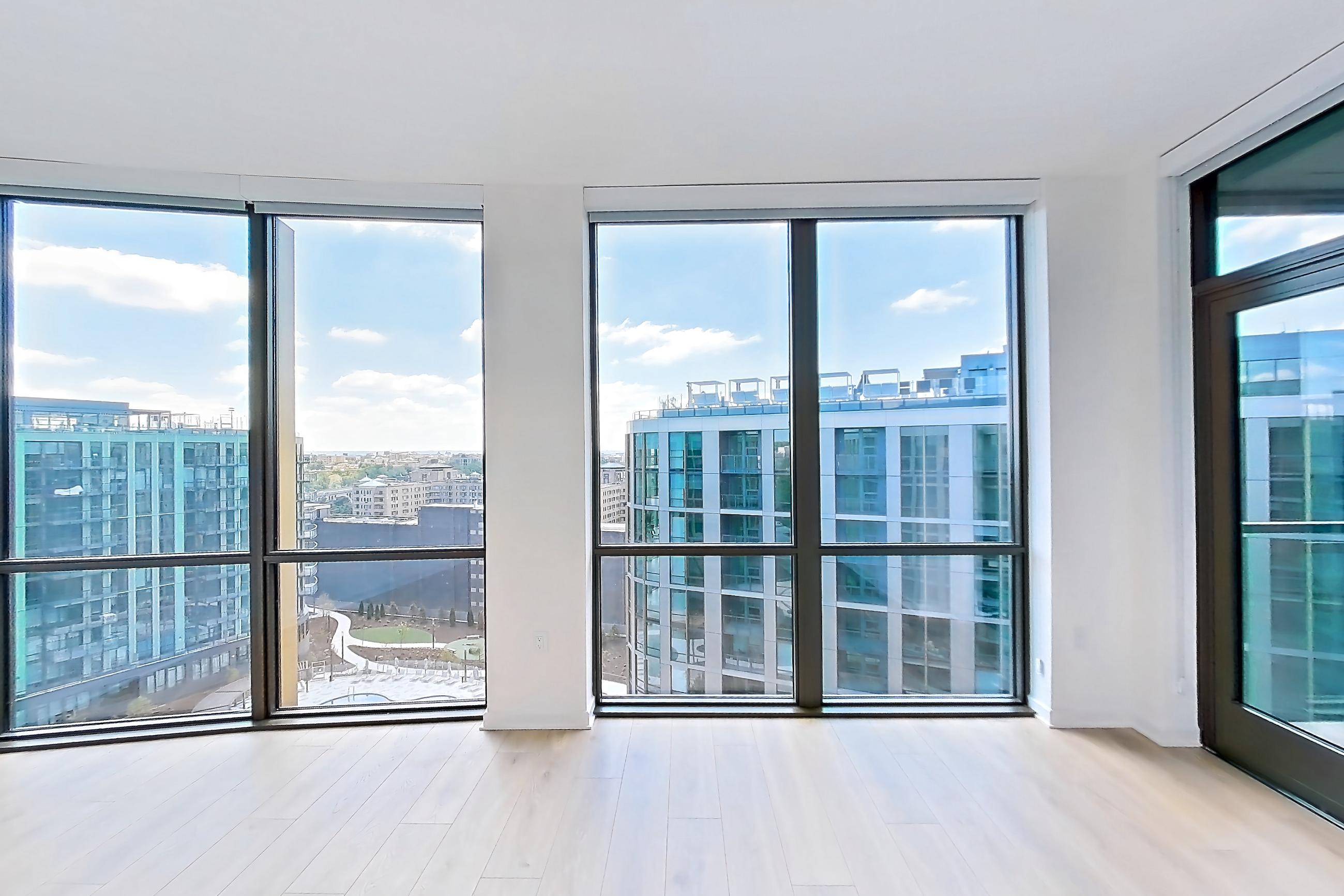 Living room with city view, light wood-finish flooring, and wood-finish flooring, Apartment 1633 at Zephyr