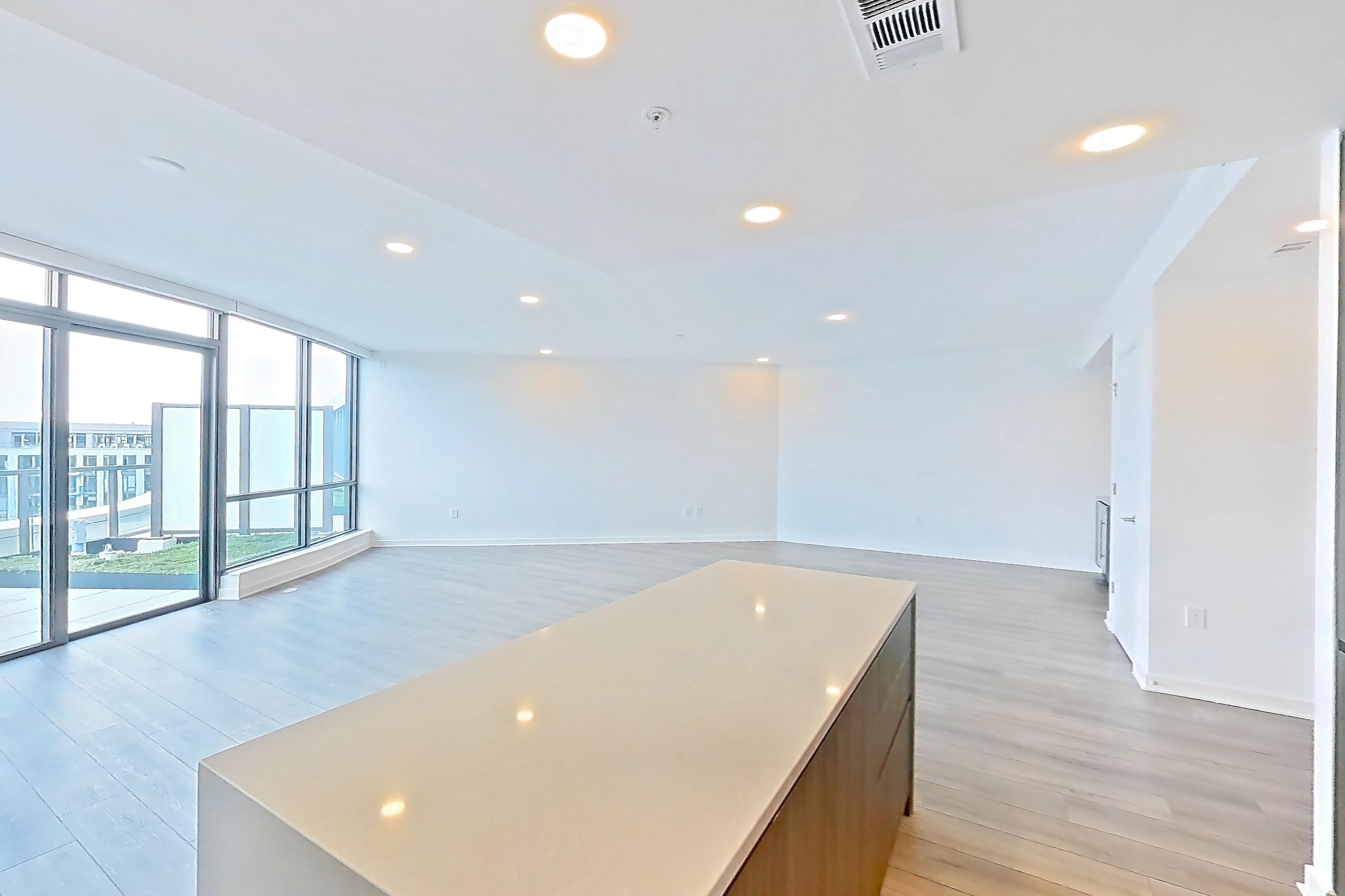 Kitchen with cooktop, gas cooktop, light stone countertops, light wood-finish flooring, oven/range, and stainless steel appliances, Apartment 1712 at Zephyr