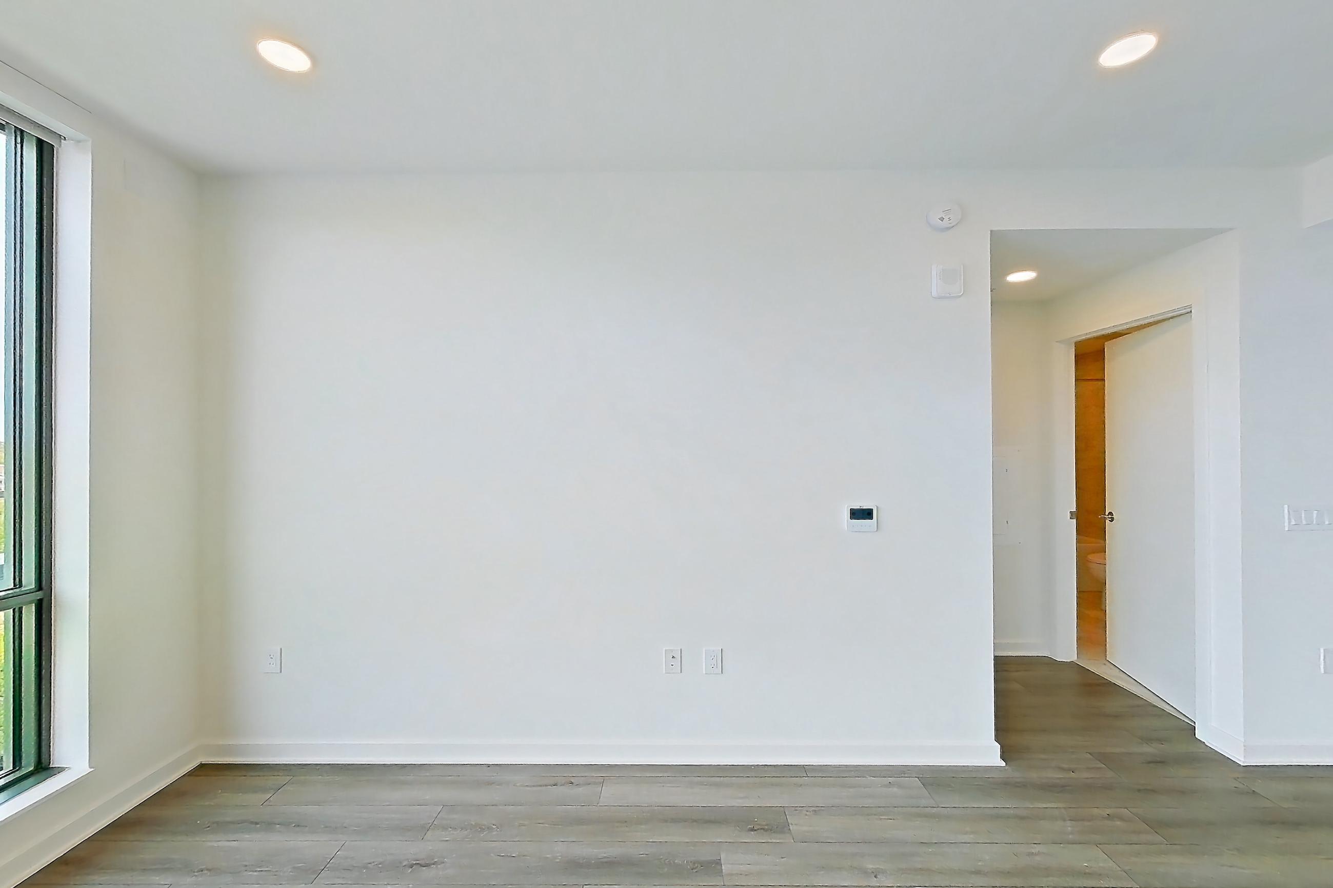 Living room with light wood-finish flooring, Apartment 1705 at Zephyr