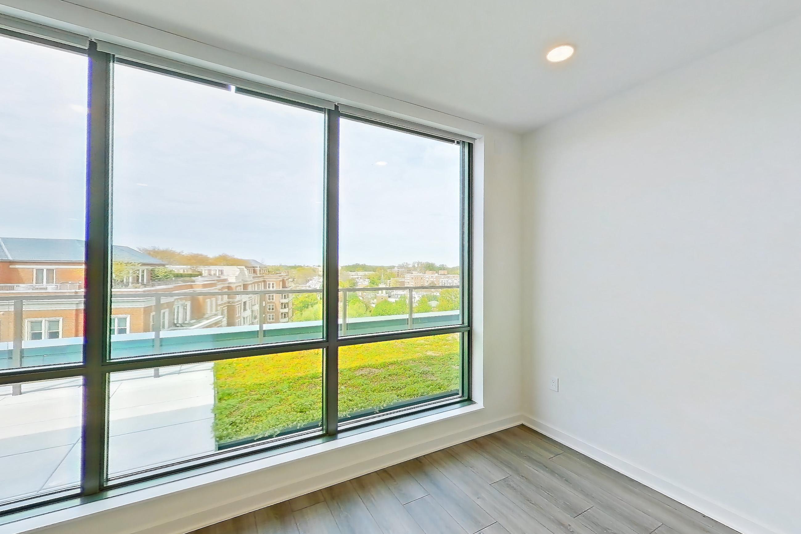 Living room with light wood-finish flooring, Apartment 1705 at Zephyr