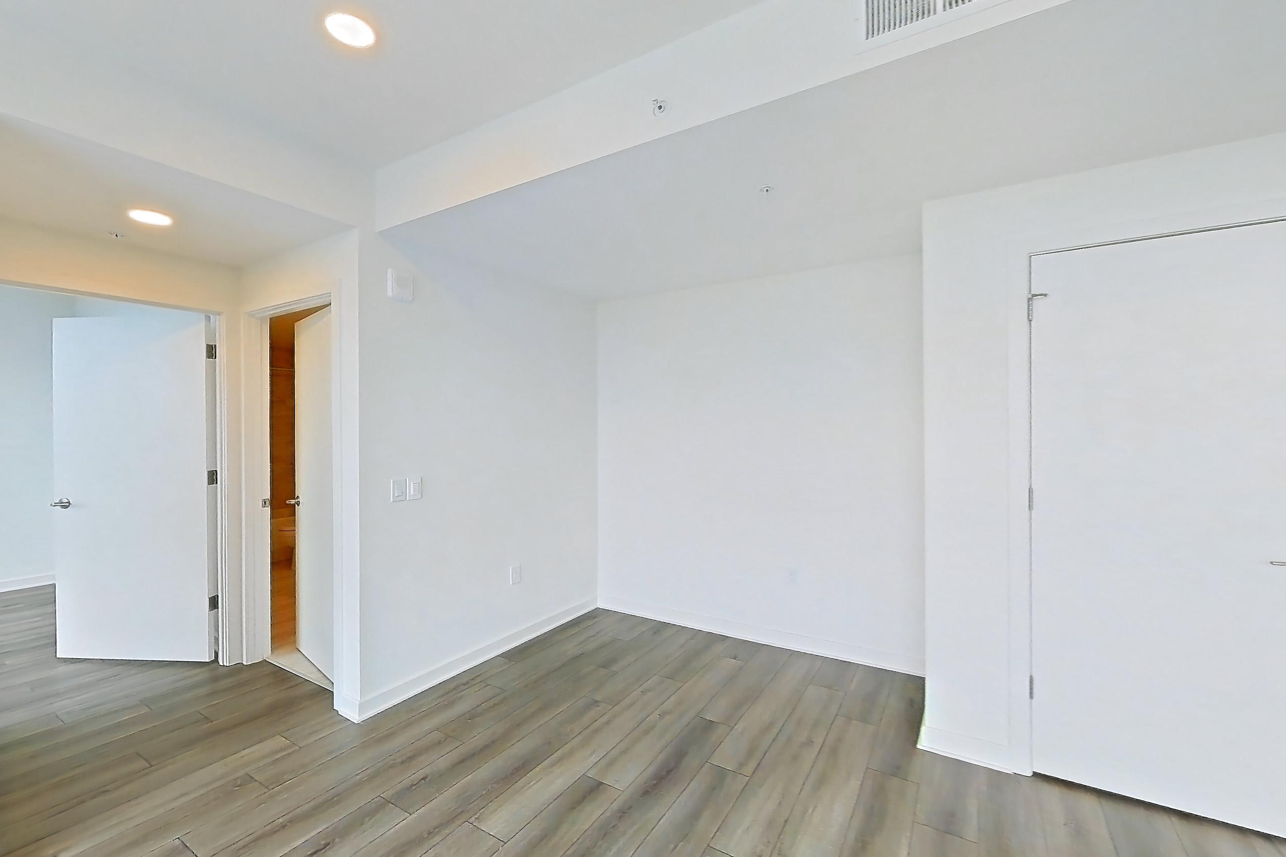 Living room with dark wood-finish flooring and light wood-finish flooring, Apartment 1711 at Zephyr