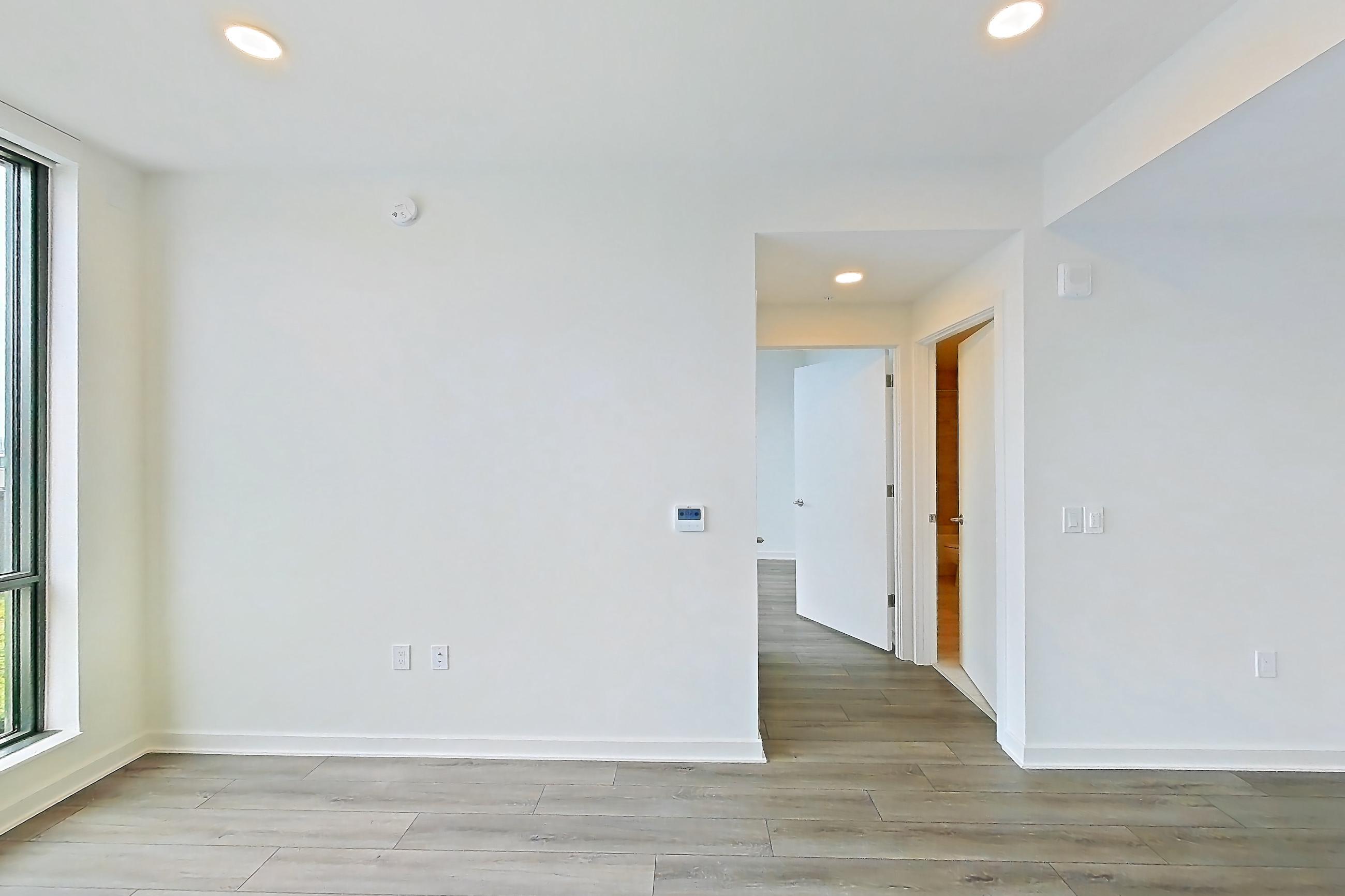 Living room with dark wood-finish flooring and light wood-finish flooring, Apartment 1711 at Zephyr