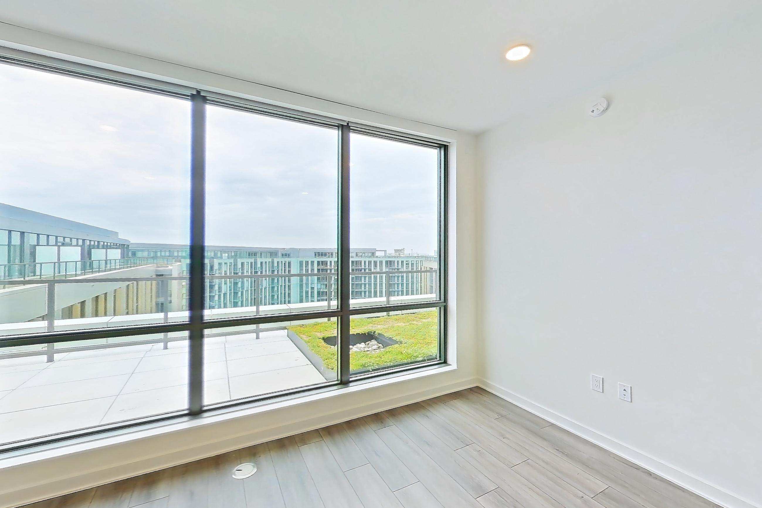 Living room with dark wood-finish flooring and light wood-finish flooring, Apartment 1711 at Zephyr