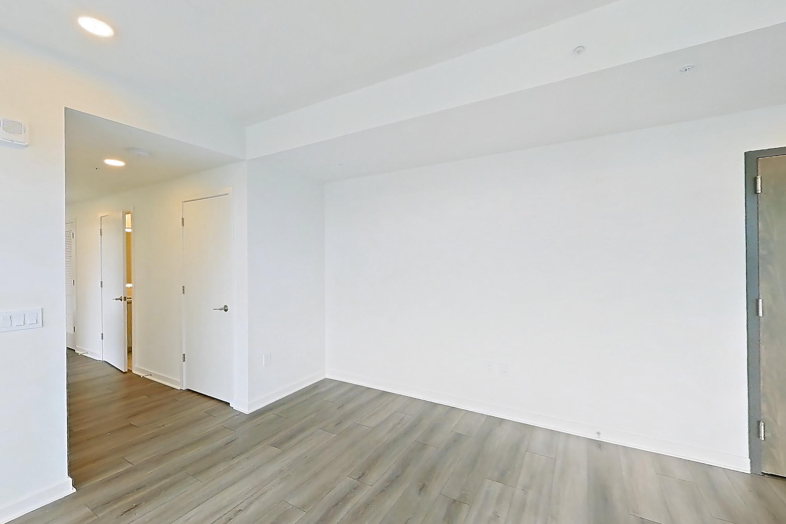 Living room with dark wood-finish flooring and light wood-finish flooring, Apartment 1707 at Zephyr