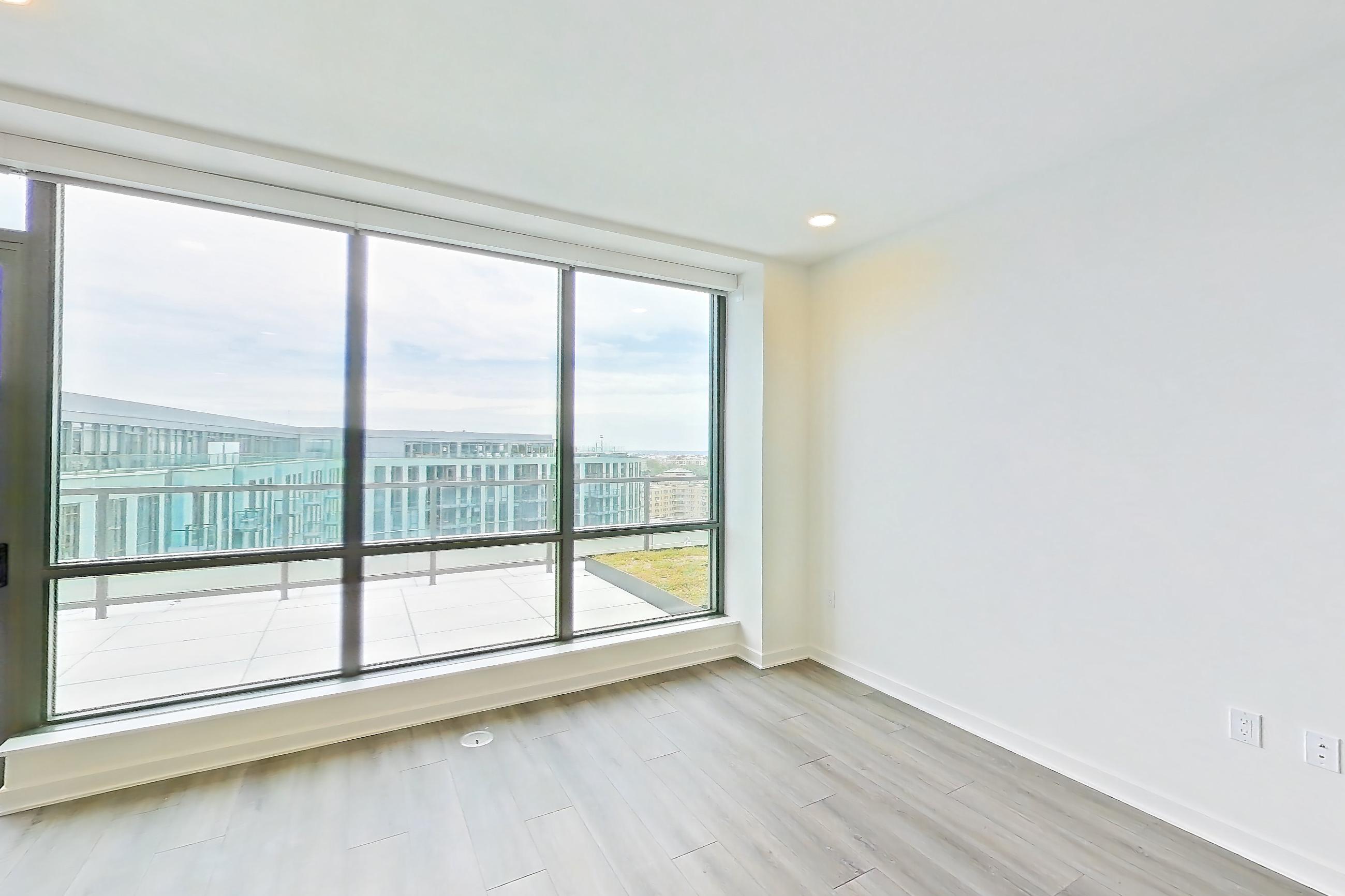Living room with dark wood-finish flooring and light wood-finish flooring, Apartment 1707 at Zephyr