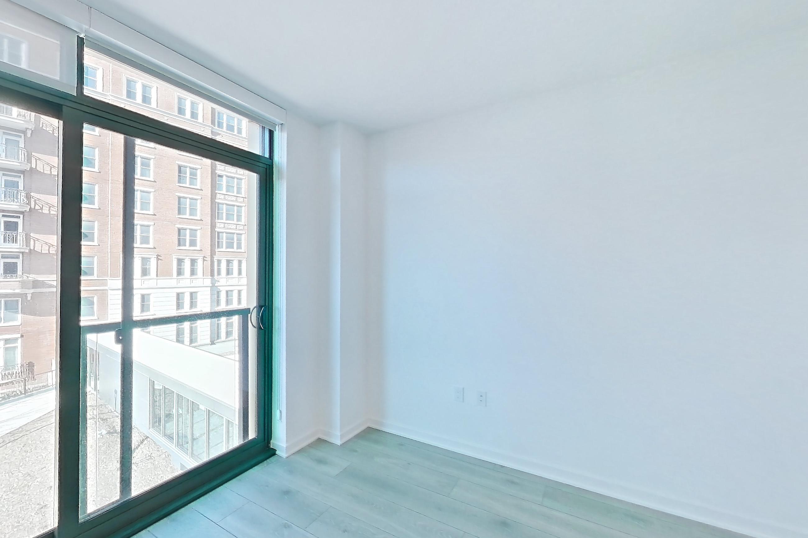 Living room with light wood-finish flooring, Apartment 1020 at Zephyr