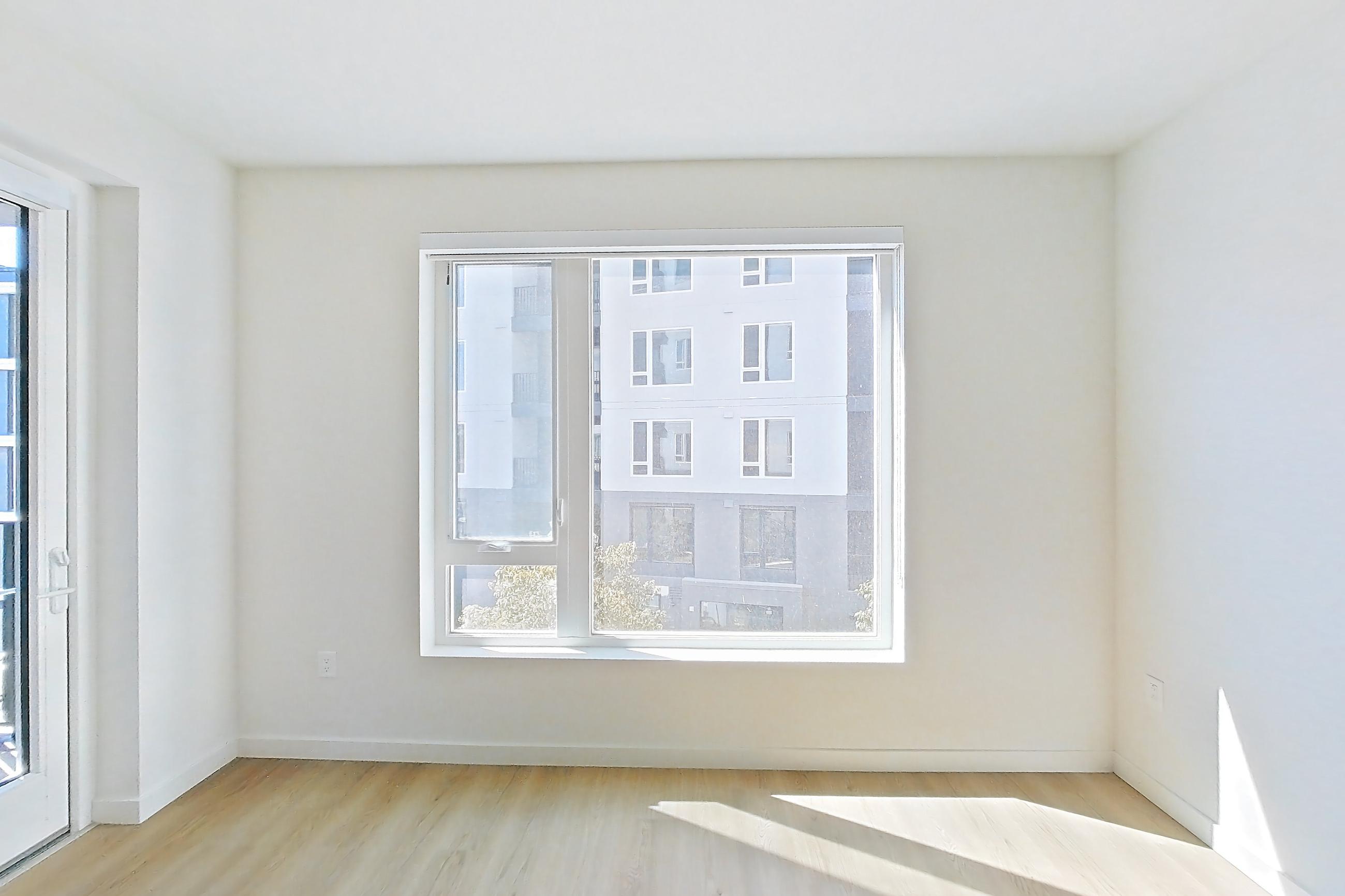 Living room with light wood-finish flooring, Apartment 343 at Revery
